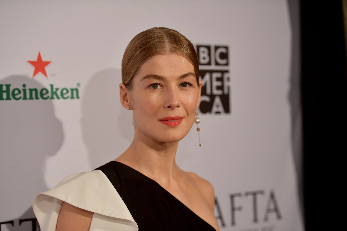 Rosamund Pike posing while wearing a dress