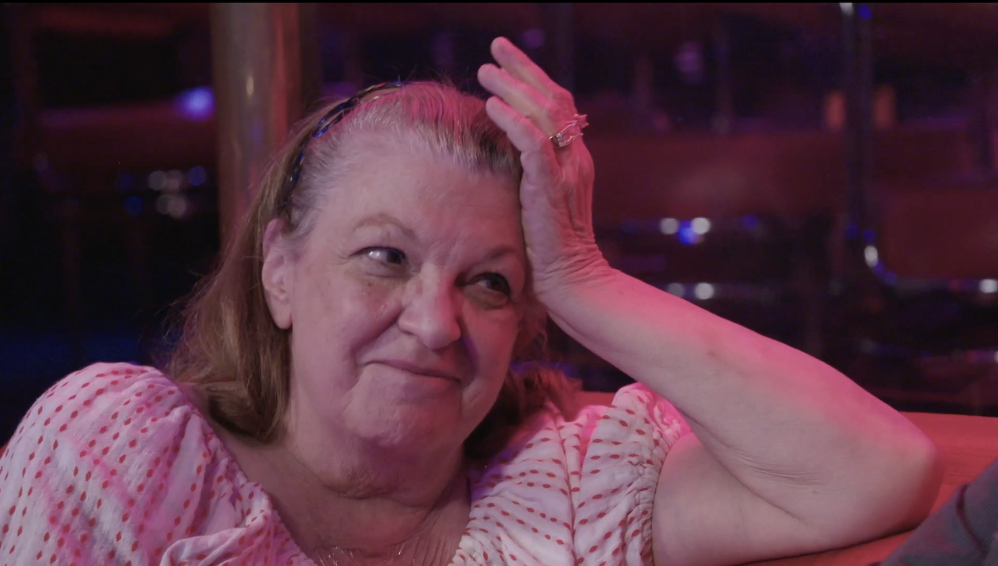 '90 Day Fiancé' star Debbie Johnson in a pink and white blouse in a still from 90 Day: The Single Life.