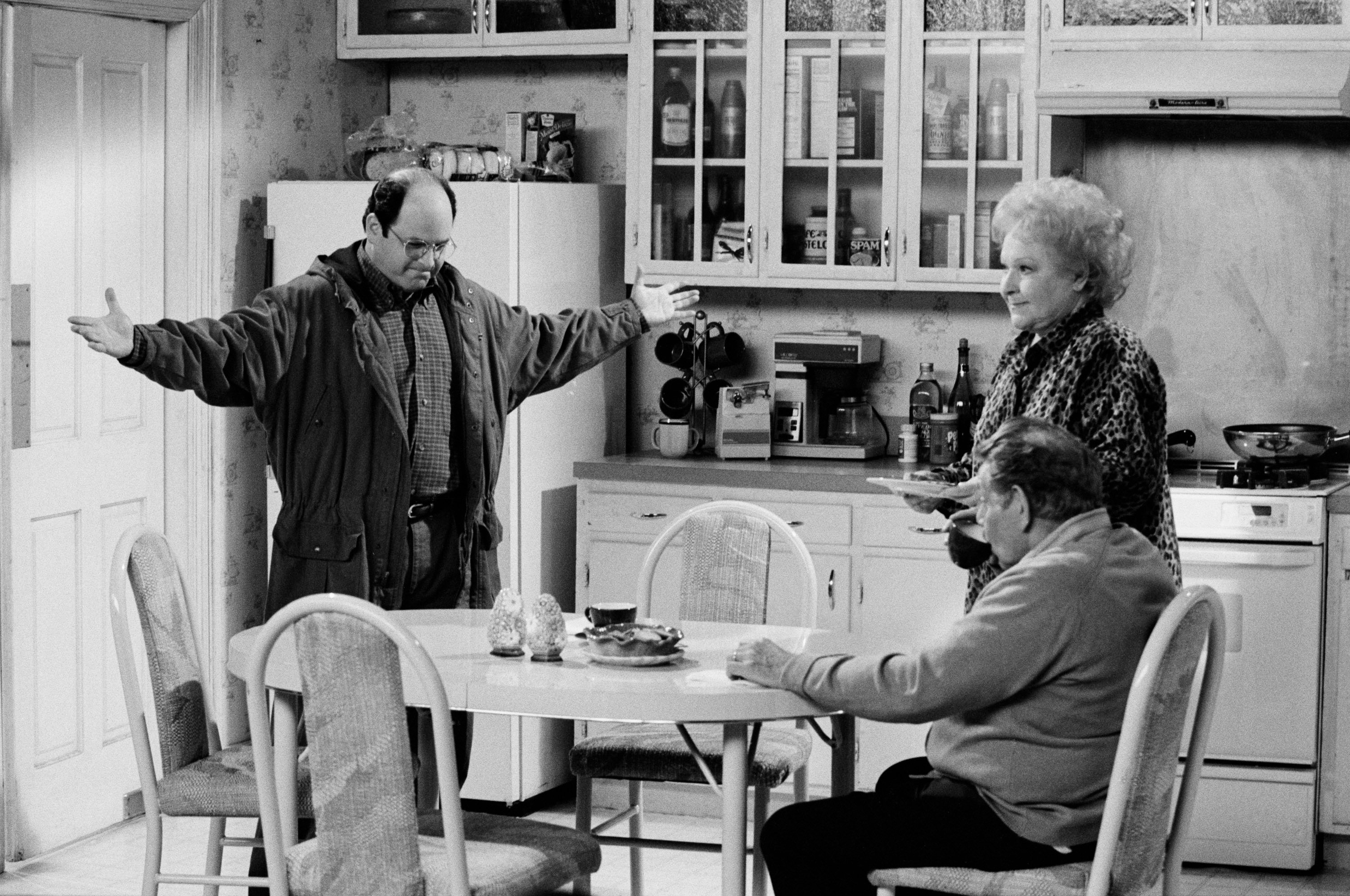Jason Alexander with Estelle Harris and Jerry Stiller in their kitchen during the filming of 'Seinfeld'