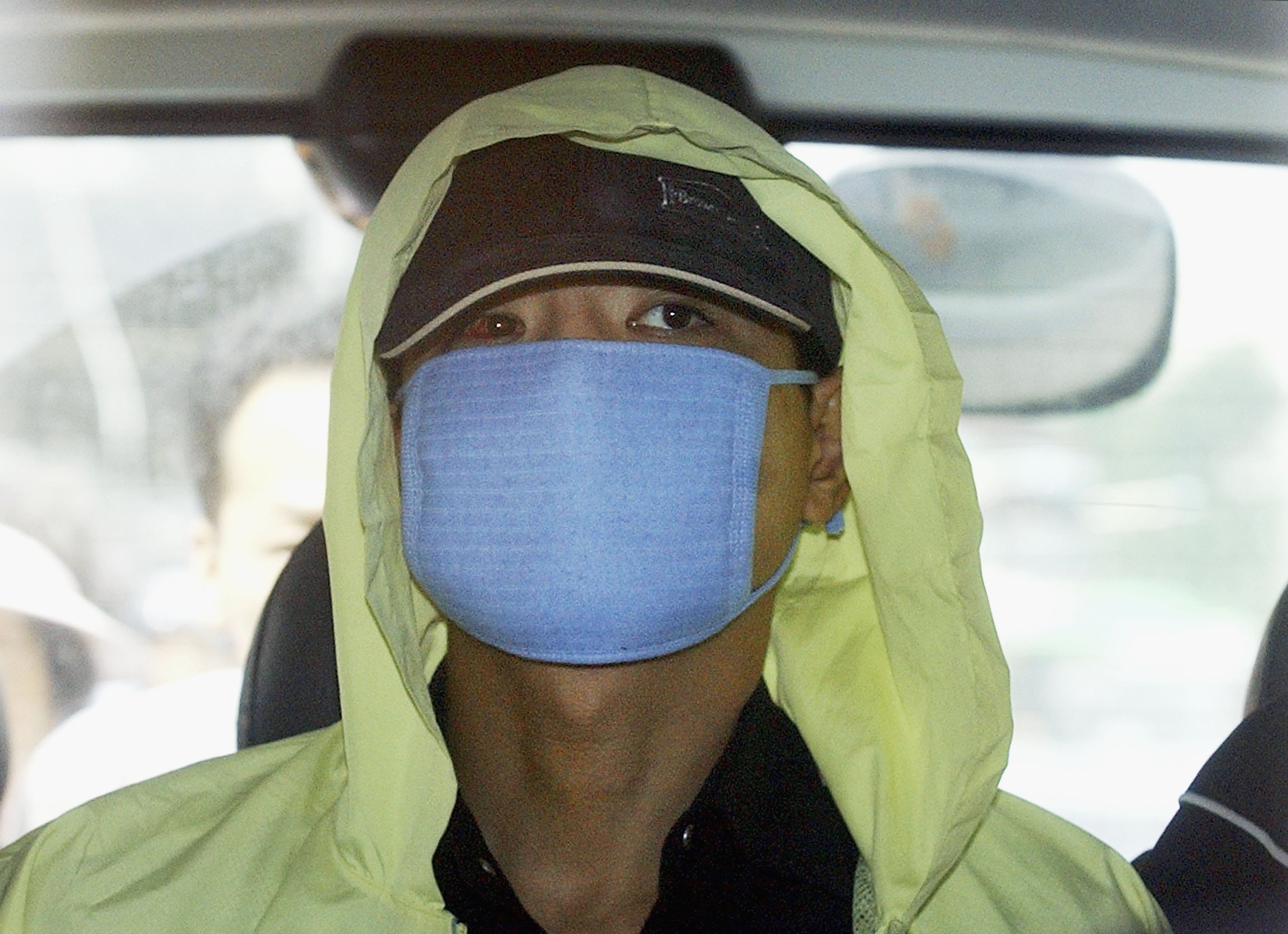 Serial Killer Yoo Young-chul 'The Raincoat Killer' wearing blue mask and yellow raincoat.