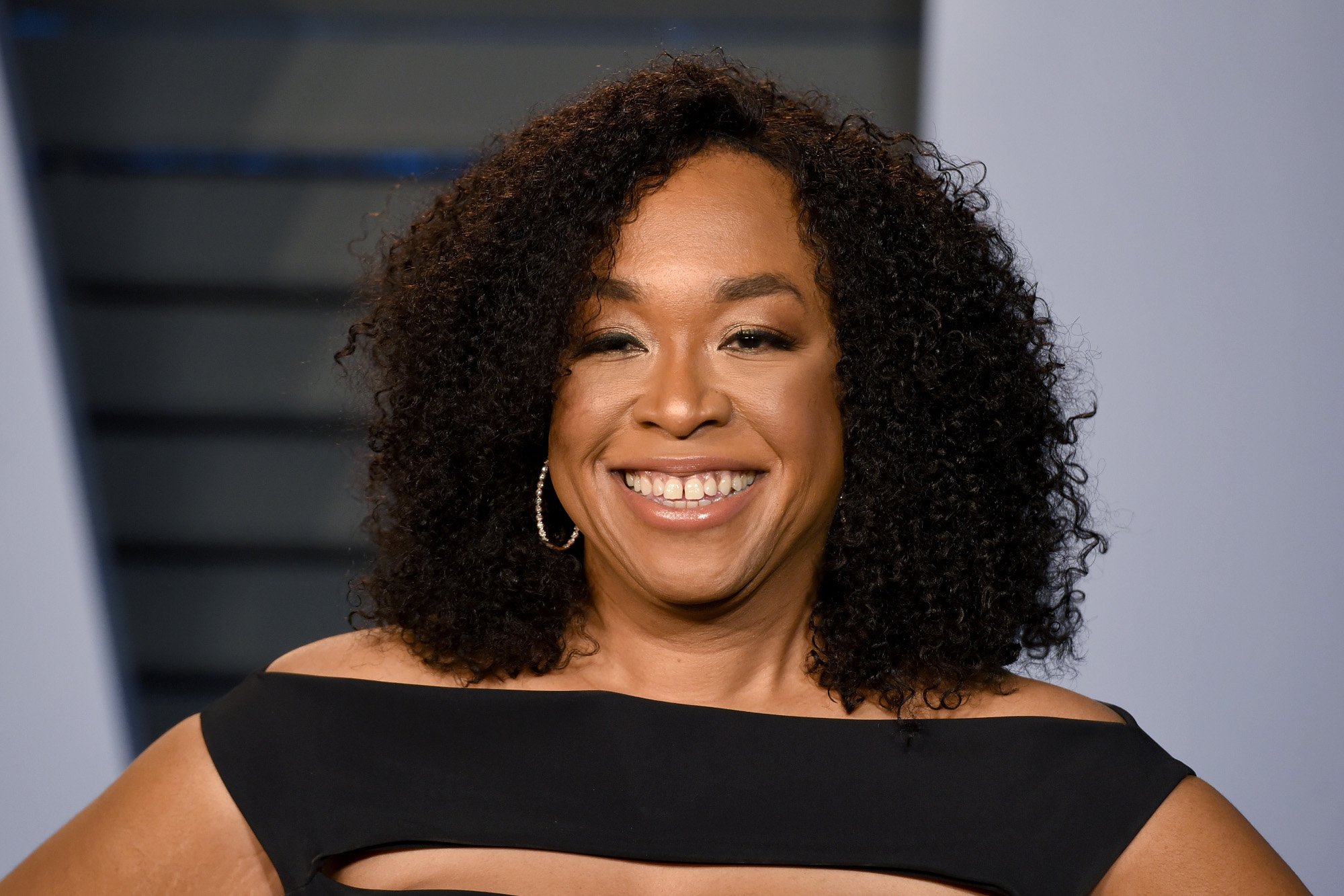'Grey's Anatomy' creator Shonda Rhimes, who still isn't sure about how or when the series is ending. She's wearing a black dress, her hair is down and curled, and she's smiling.
