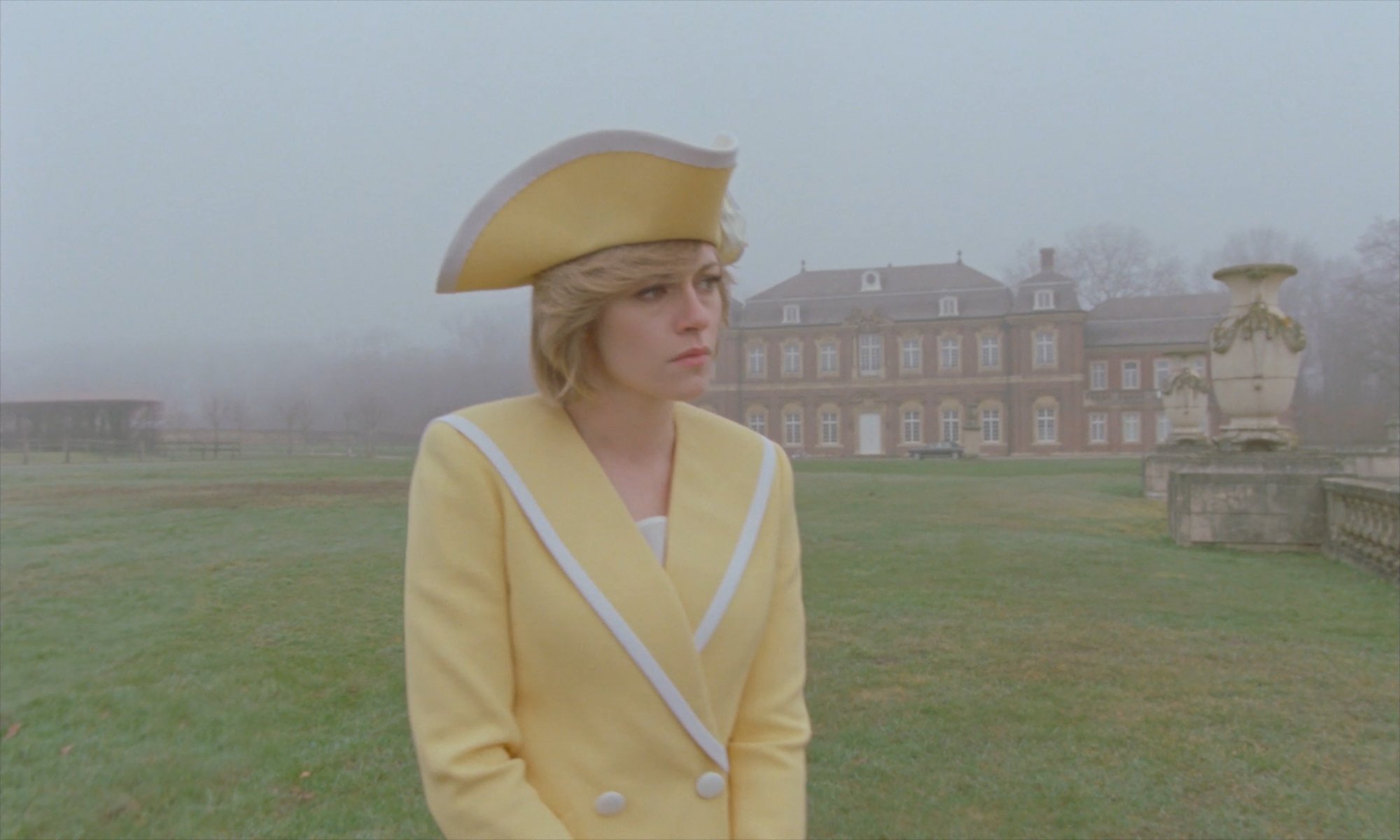 'Spencer' star Kristen Stewart as Princess Diana at Sandringham wearing a bright yellow costume in a foggy landscape