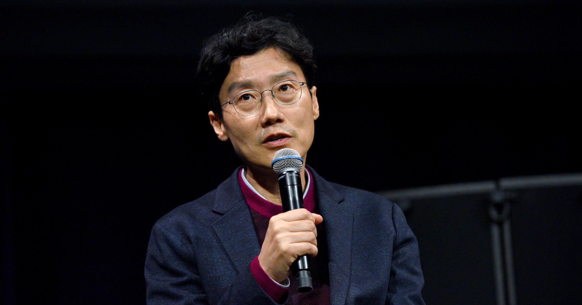 'Squid Game' director Hwang Dong-hyuk in relation to 'Bridgerton' comment holding microphone.