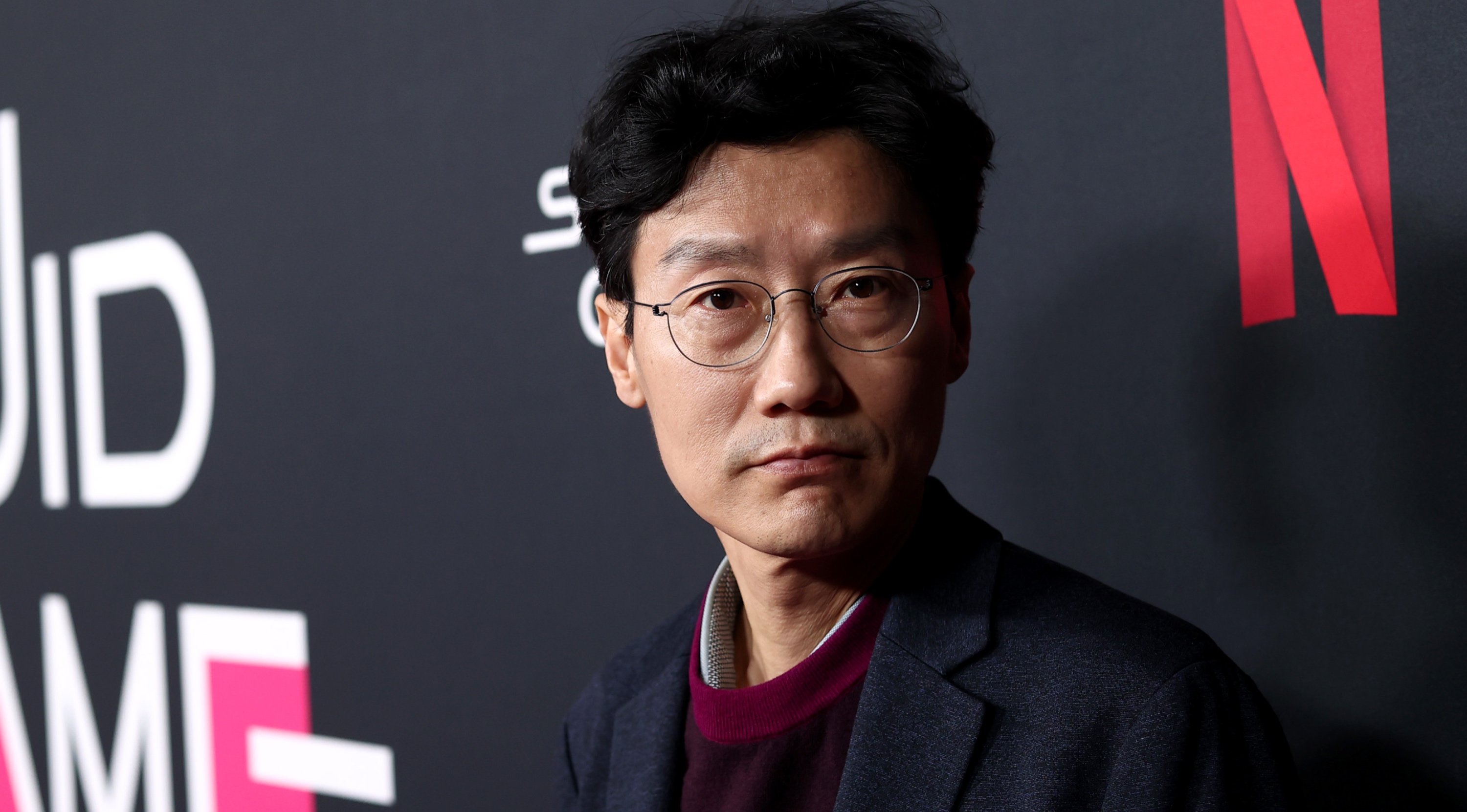 'Squid Game' director Hwang Dong-hyuk in front on red carpet photo op.