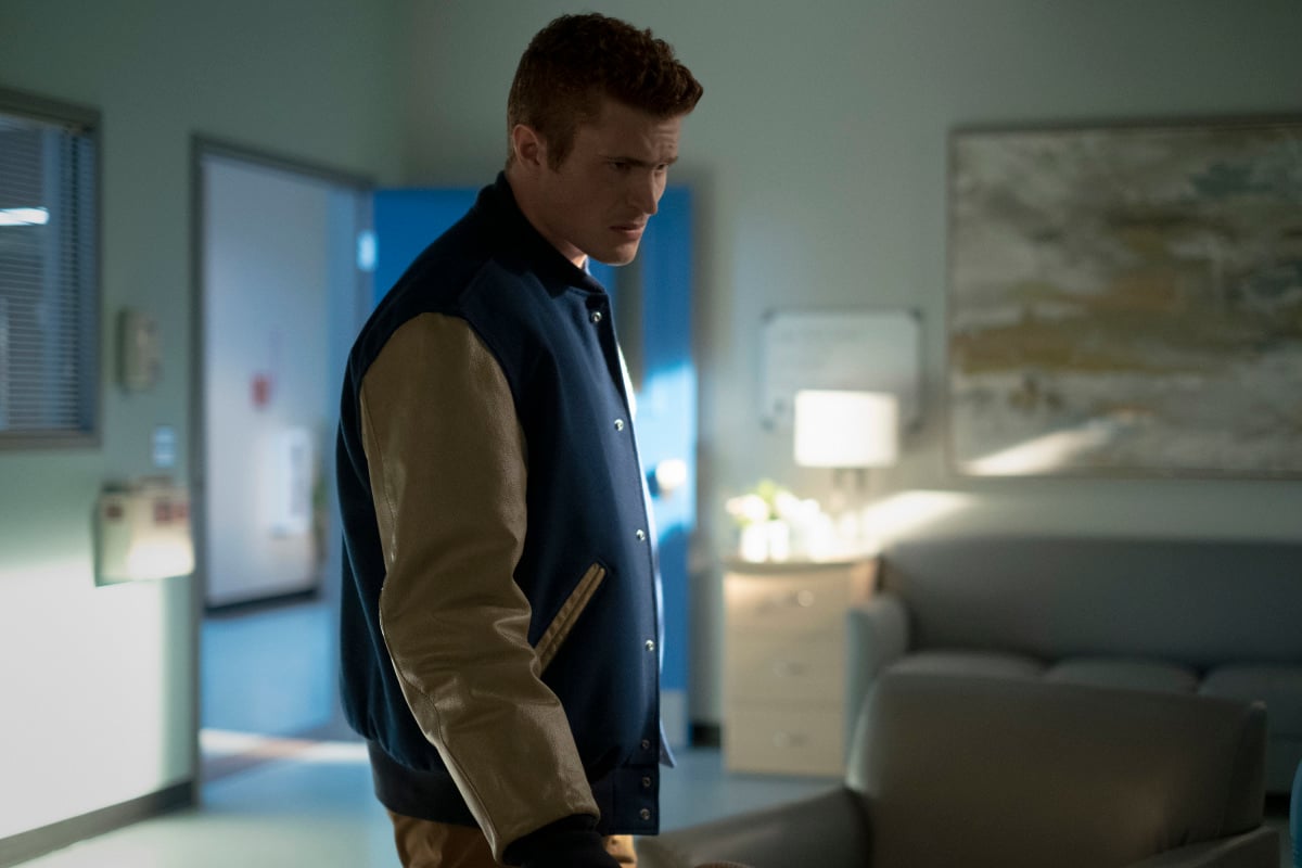 'Stargirl' actor Jake Austin Walker, in character as Henry King Jr., wears a blue and gold letterman jacket. Many fans believe that Henry is still alive after the season 2 finale.