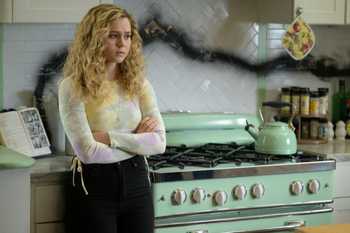 'Stargirl' actor Brec Bassinger, in character as Courtney Whitmore, wears a yellow, green, and purple tie dyed long-sleeved shirt and black pants. 'Stargirl' Season 2 is coming soon to HBO Max.