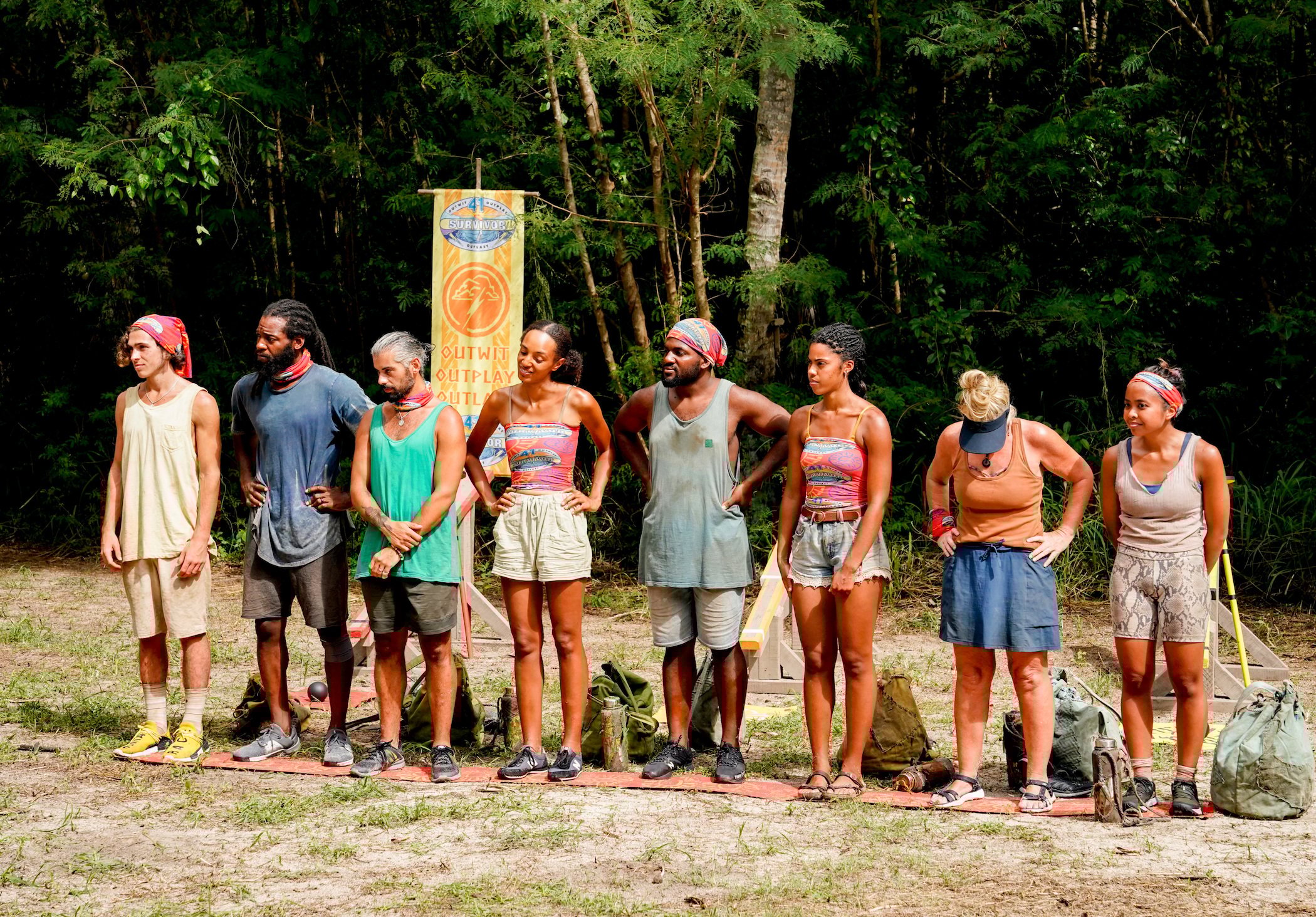 The 'Survivor' Season 41 cast standing in a line outside ready to hear about a challenge. 'Survivor' Season 41 spoilers note Shan gets blindsided and sent home.