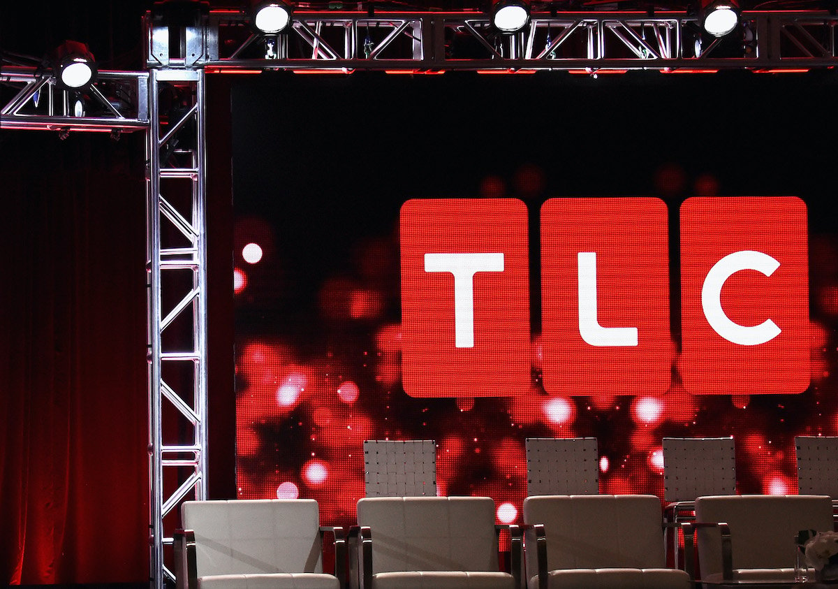 TLC logo above a set of chairs on a stage