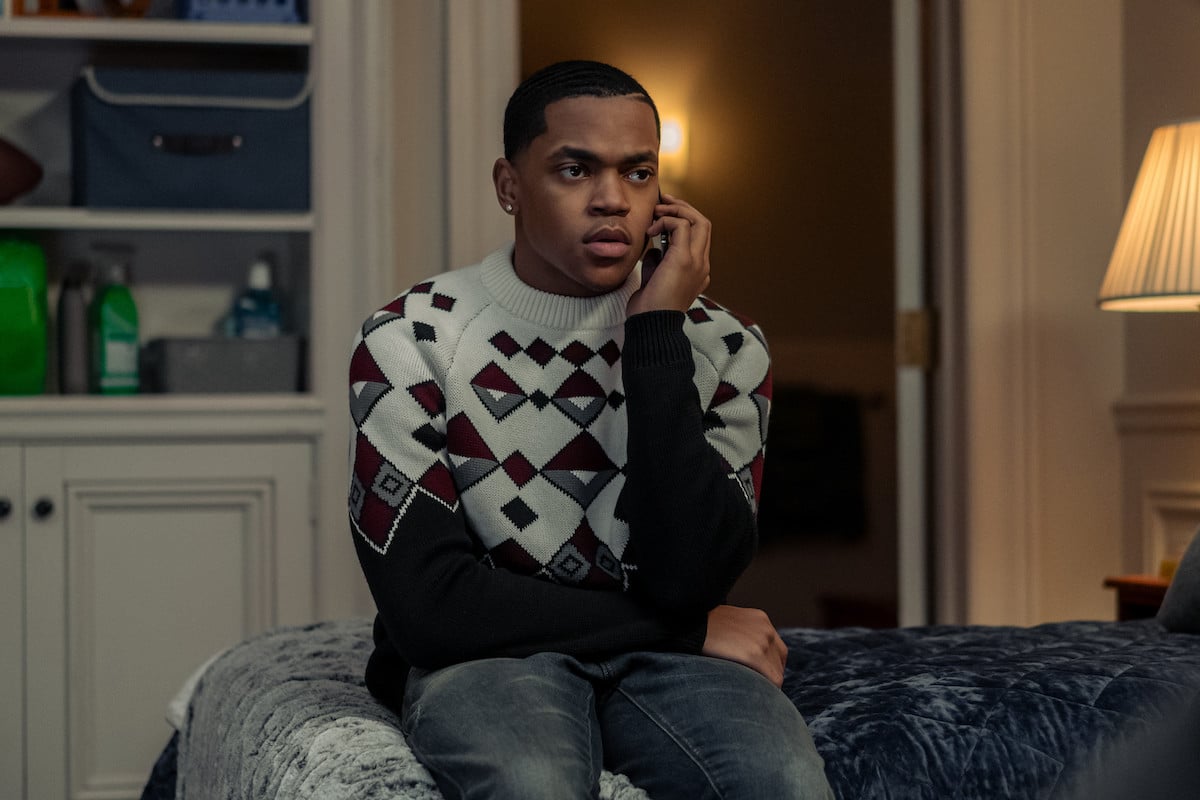 Michael Rainey Jr. as Tariq St. Patrick sitting on the bed talking on the phone wearing a sweater in 'Power Book II: Ghost' 