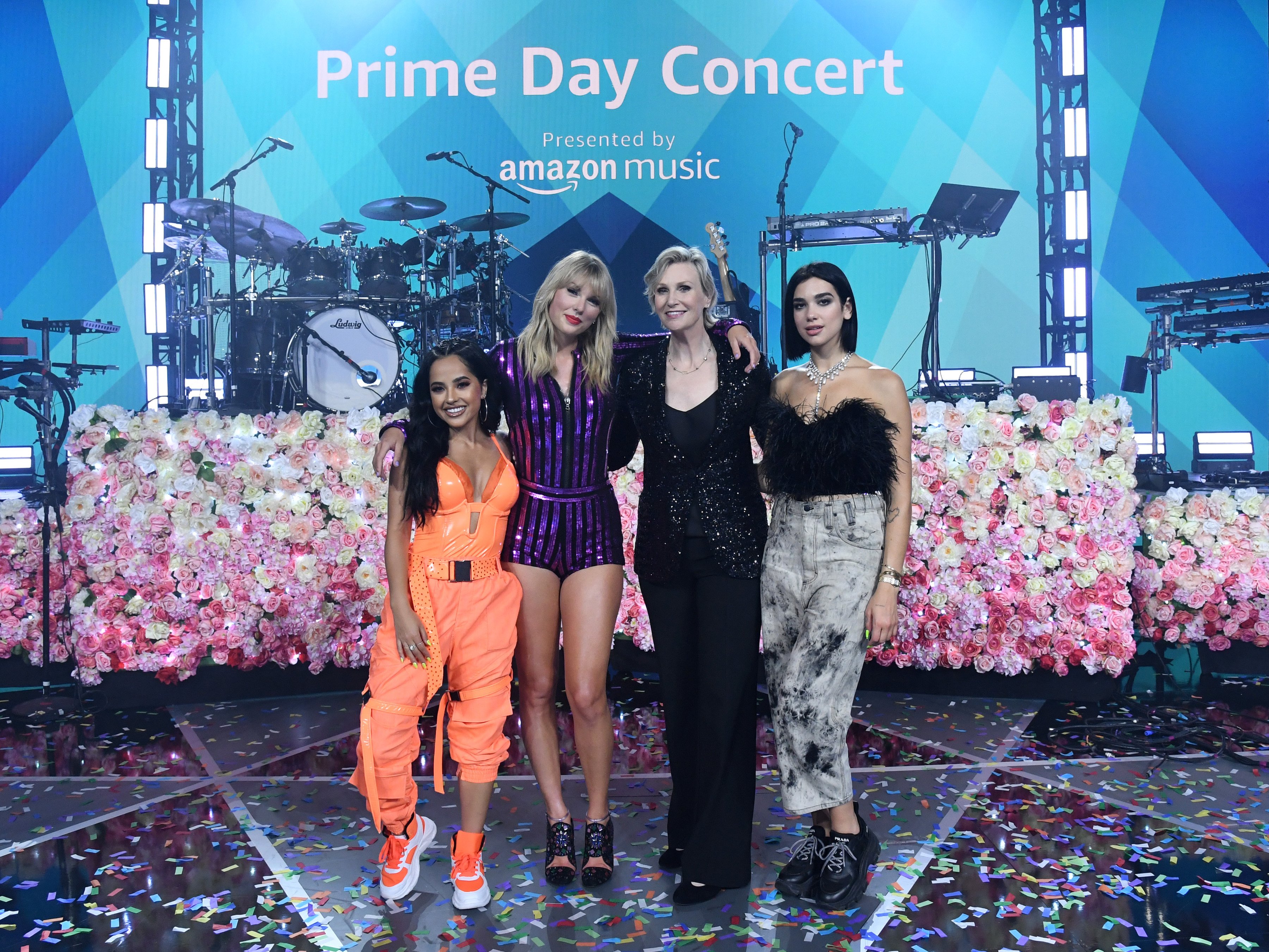 Becky G, Taylor Swift, Jane Lynch, and Dua Lipa pose on stage