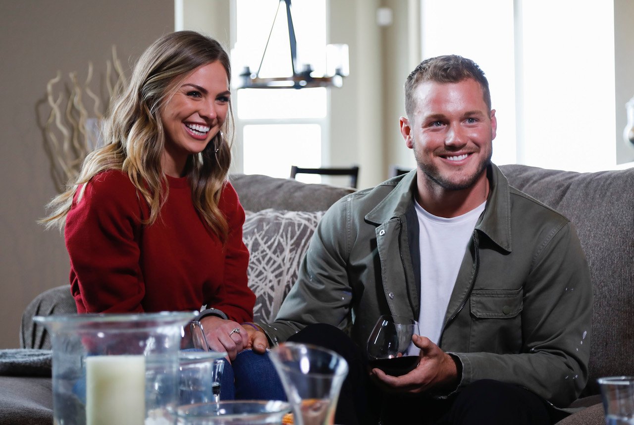 Hannah Brown and Colton Underwood sit on a couch smiling on 'The Bachelor'