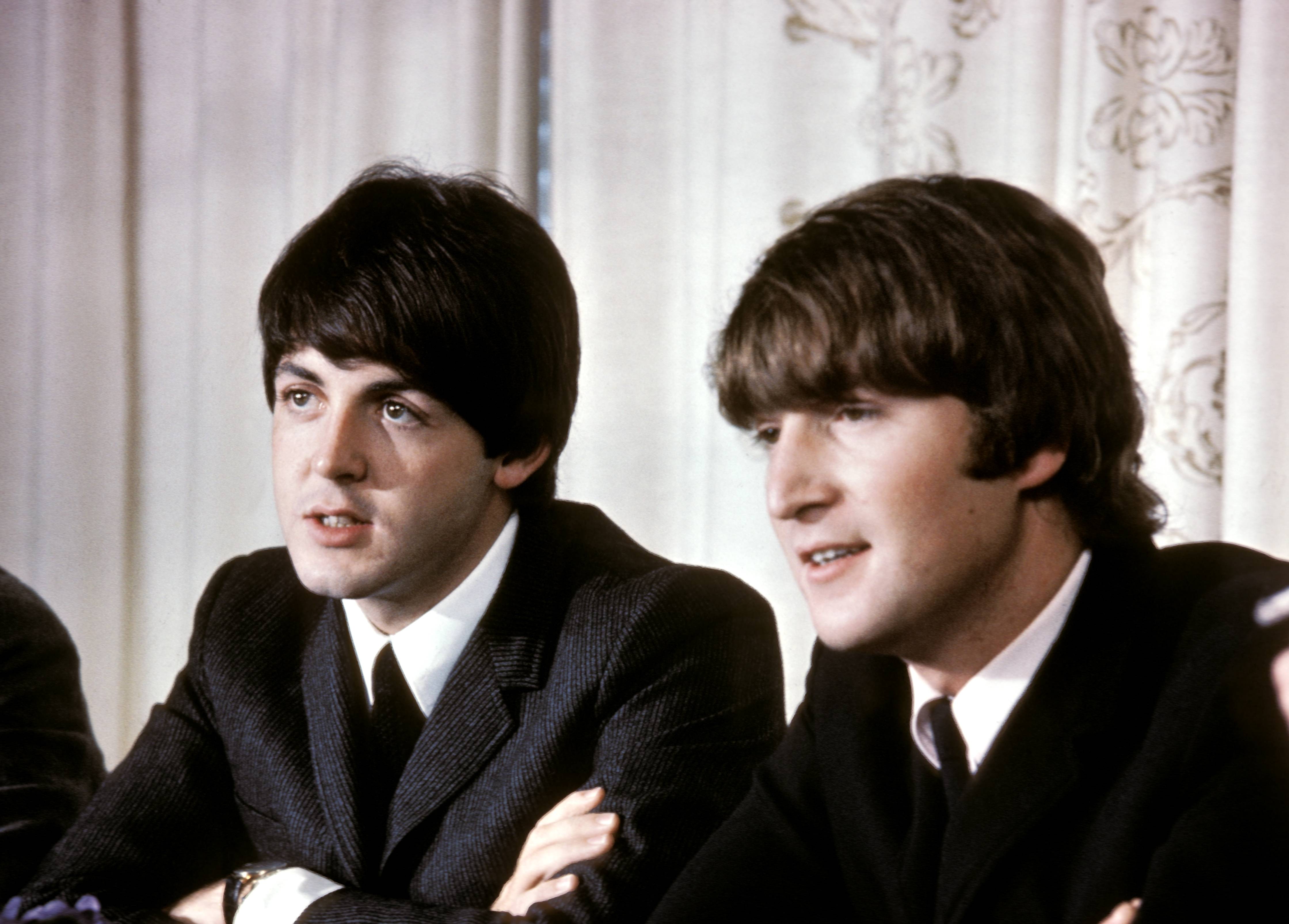 The Beatles: Paul McCartney and John Lennon sit next to each other