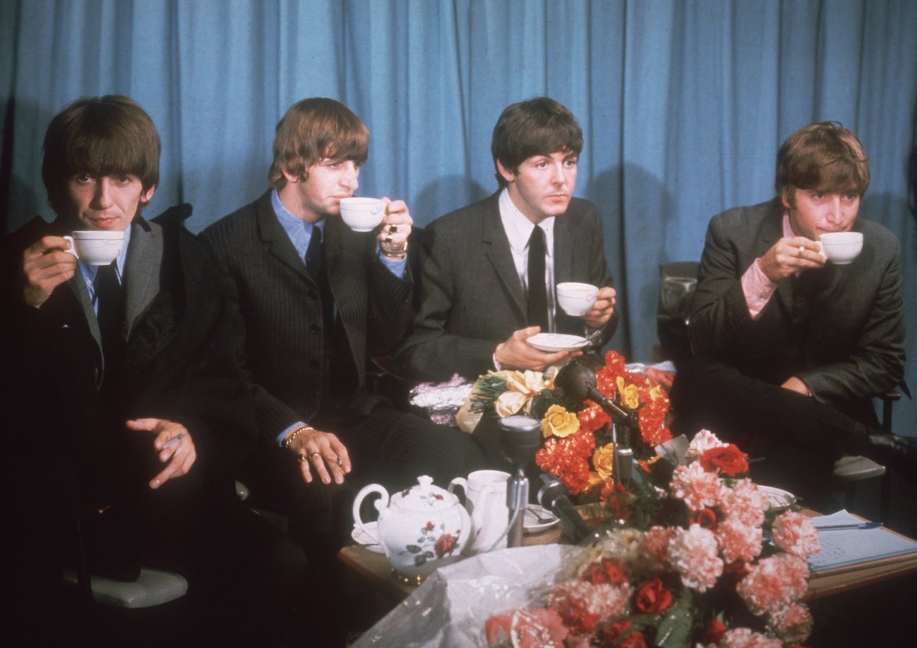 The Beatles drinking tea at a press conference at London Airport, 1964.