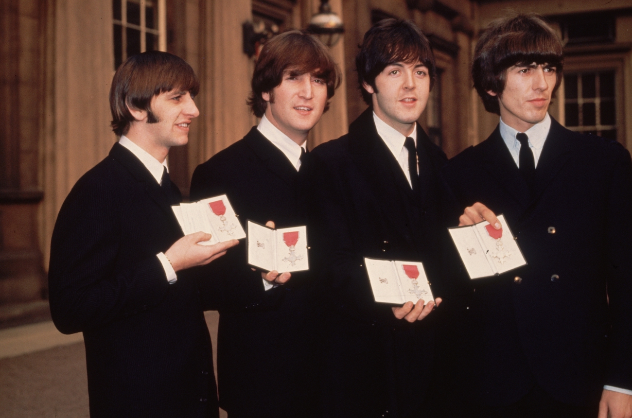 The Beatles holding their MBE awards at Buckingham Palace, 1965.