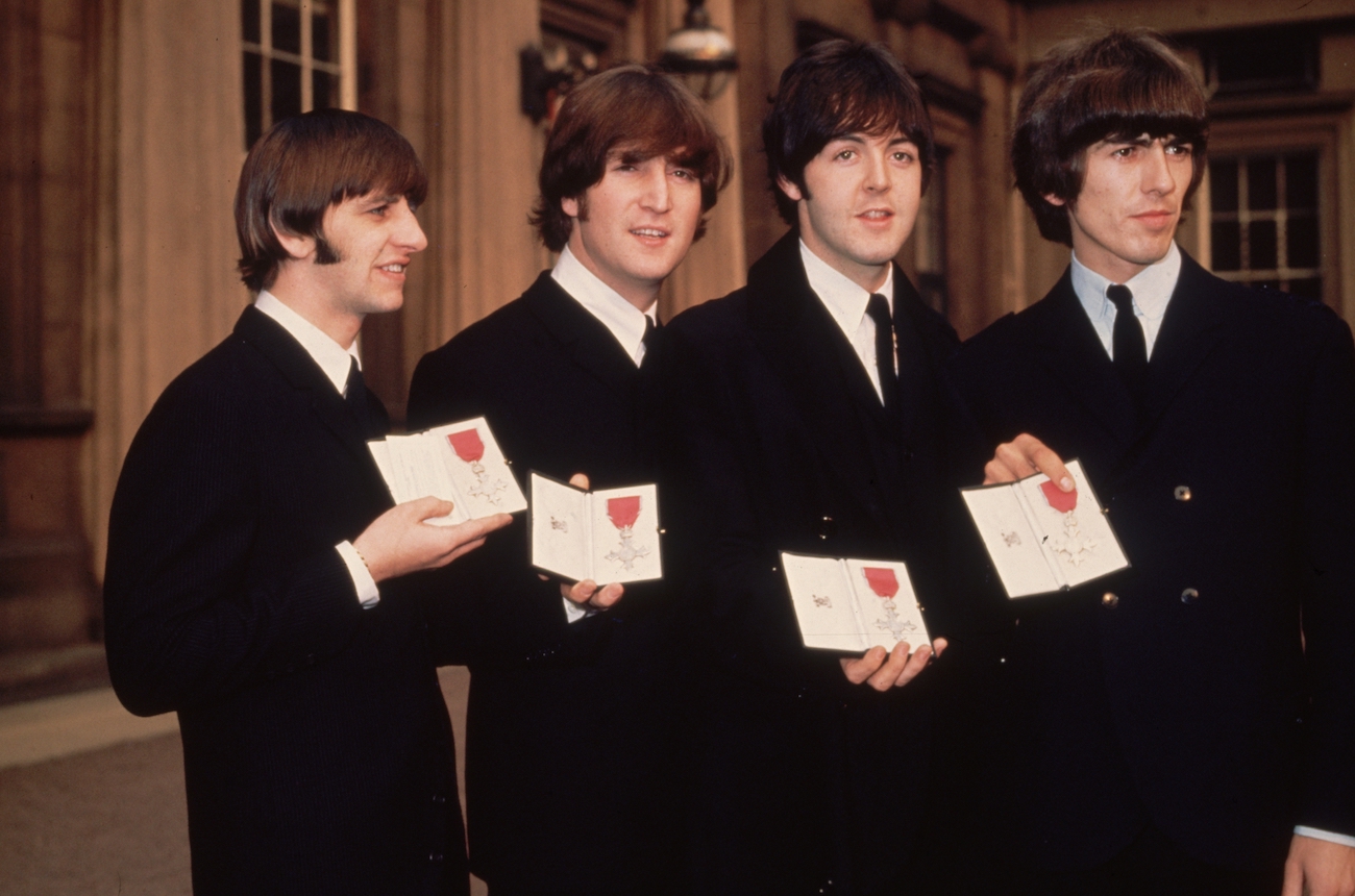 The Beatles holding their MBE awards at Buckingham Palace, 1965. 