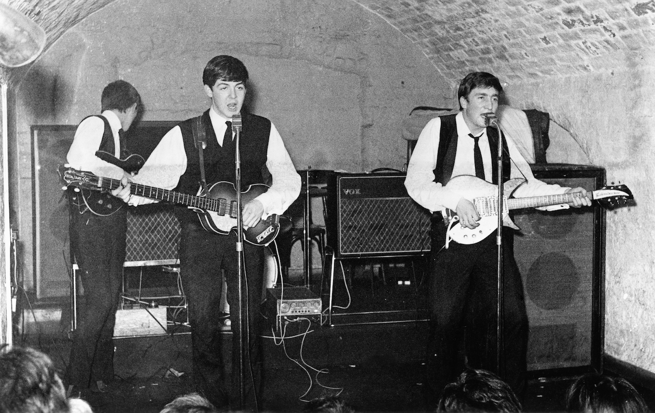 The Beatles performing in suits at the Cavern Club, Liverpool, 1962.