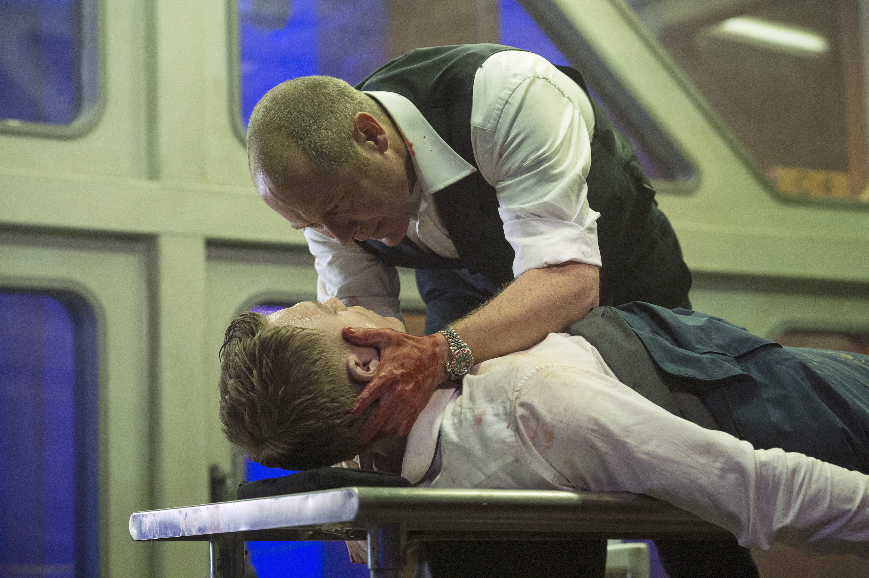 Diego Klattenhoff as Ressler and James Spader as Red in The Blacklist Season 1. Ressler lays on a table and Red holds Ressler's head in his hands.