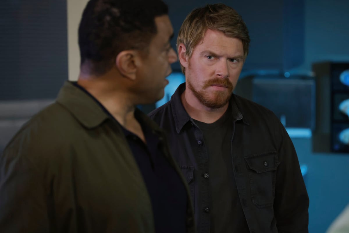 Harry Lennix as Harold Cooper and Diego Klattenhoff as Donald Ressler in The Blacklist Season 9. Cooper and Ressler look at each other.