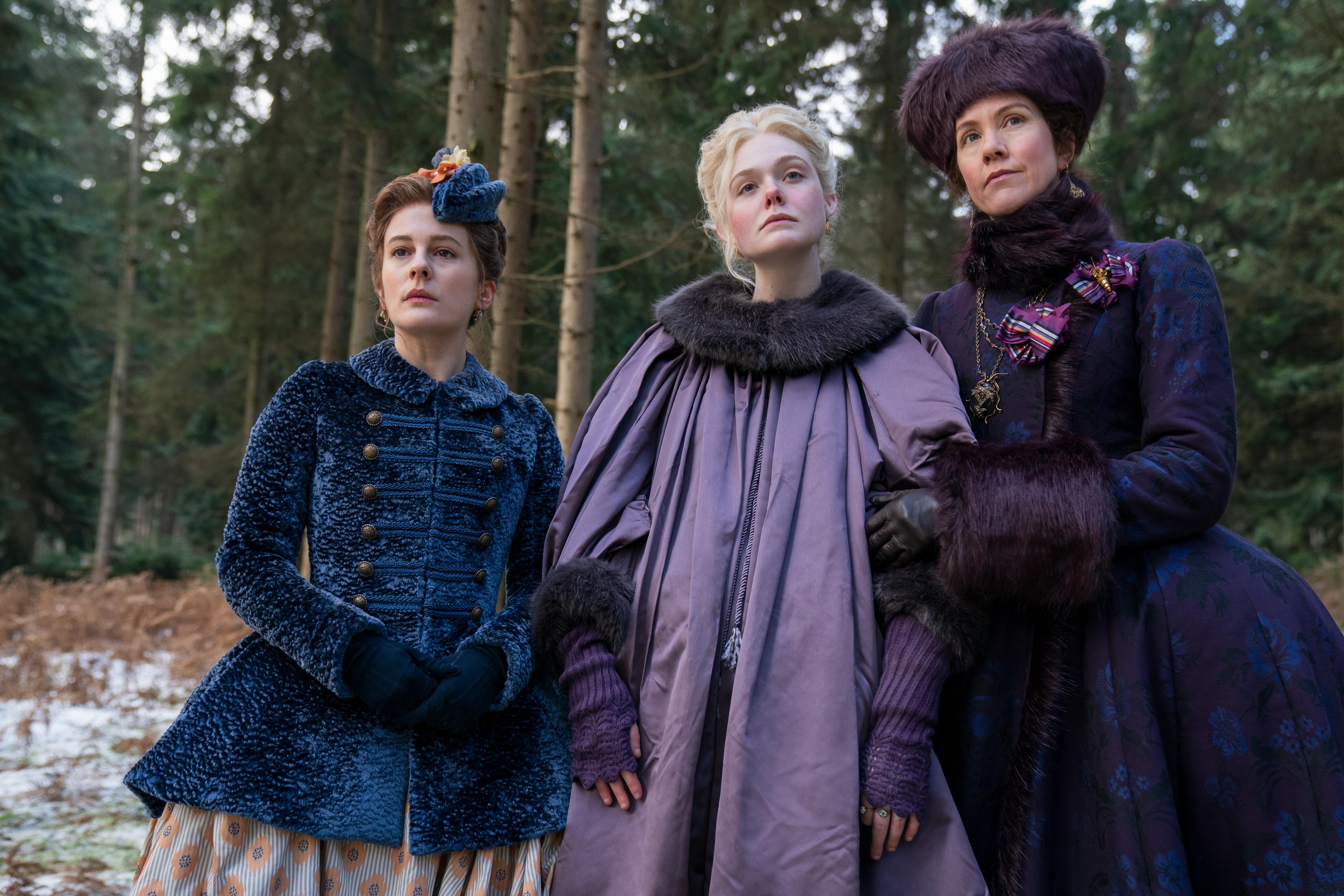 'The Great' cast members Phoebe Fox, Elle Fanning, and Belinda Bromiow standing outside