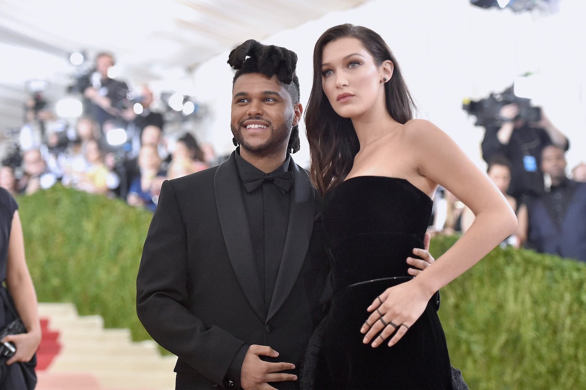 The Weeknd and Bella Hadid pose together at an event.