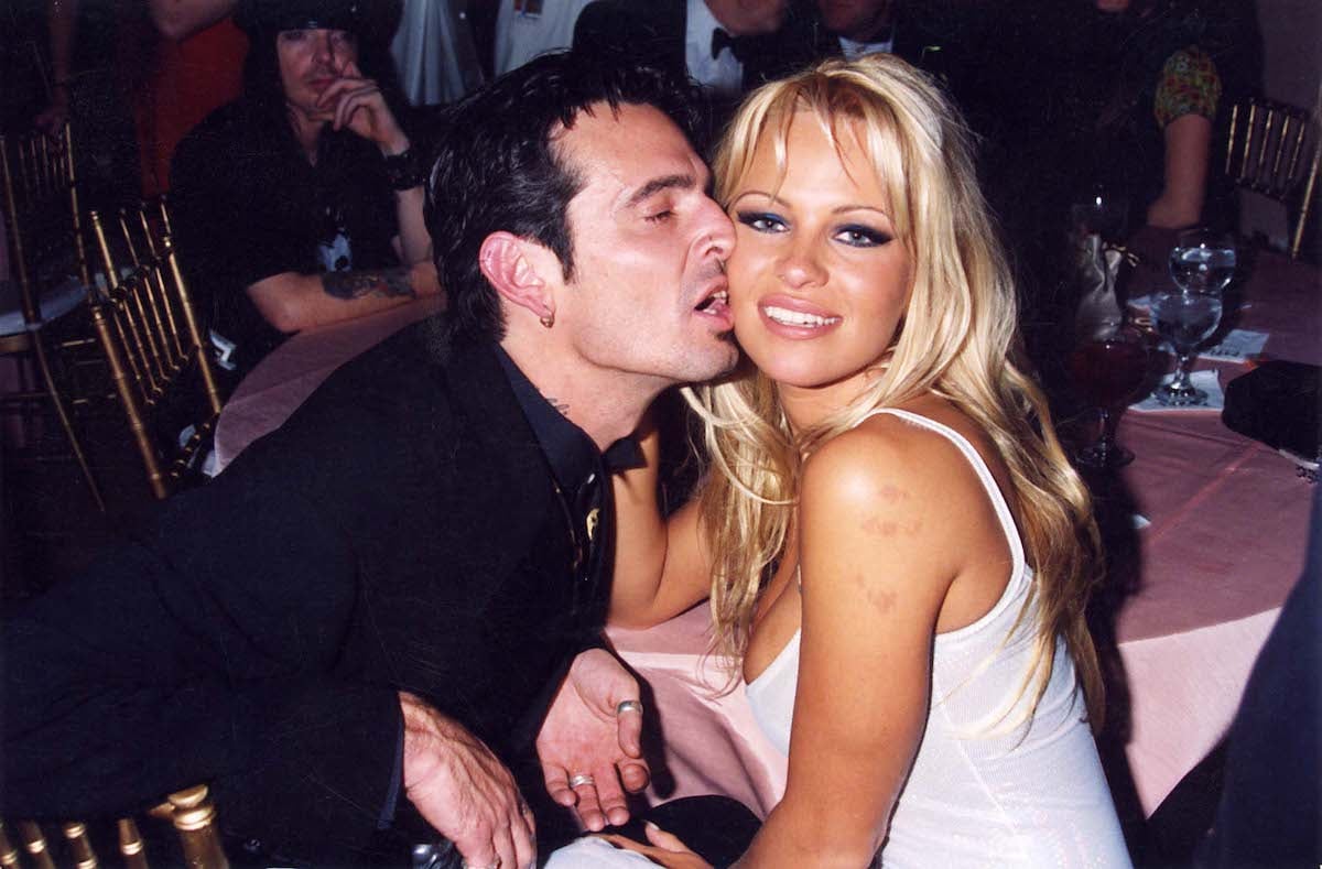 Tommy Lee kisses Pamela Anderson at an event.