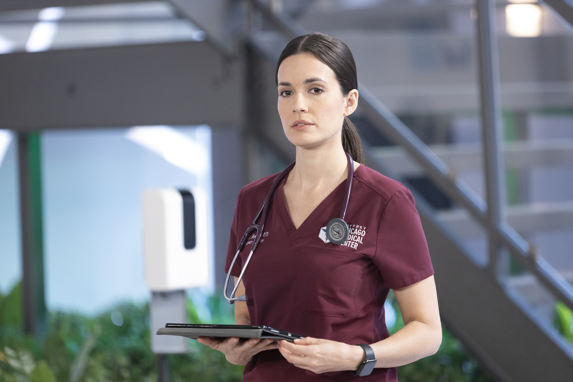 Torrey DeVitto wearing burgundy hospital scrubs in 'Chicago Med.'