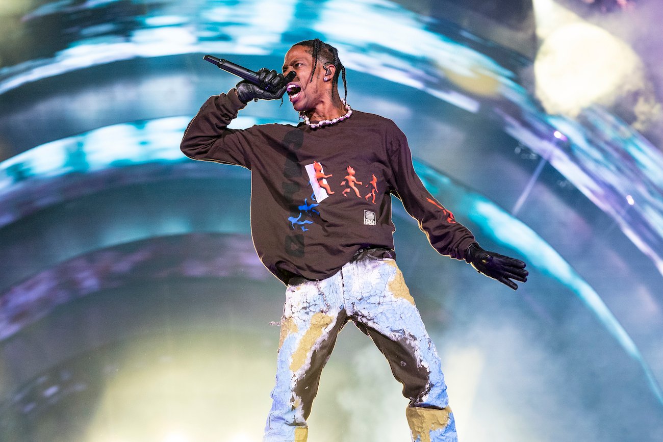 Travis Scott performing in front of a blue background at Astroworld Festival