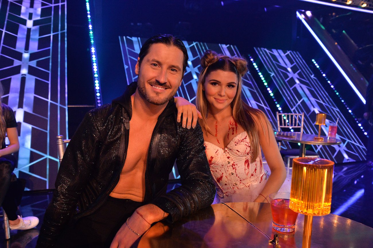 Val Chmerkovskiy and Olivia Jade sit at a table in the 'Dancing with the Stars' ballroom