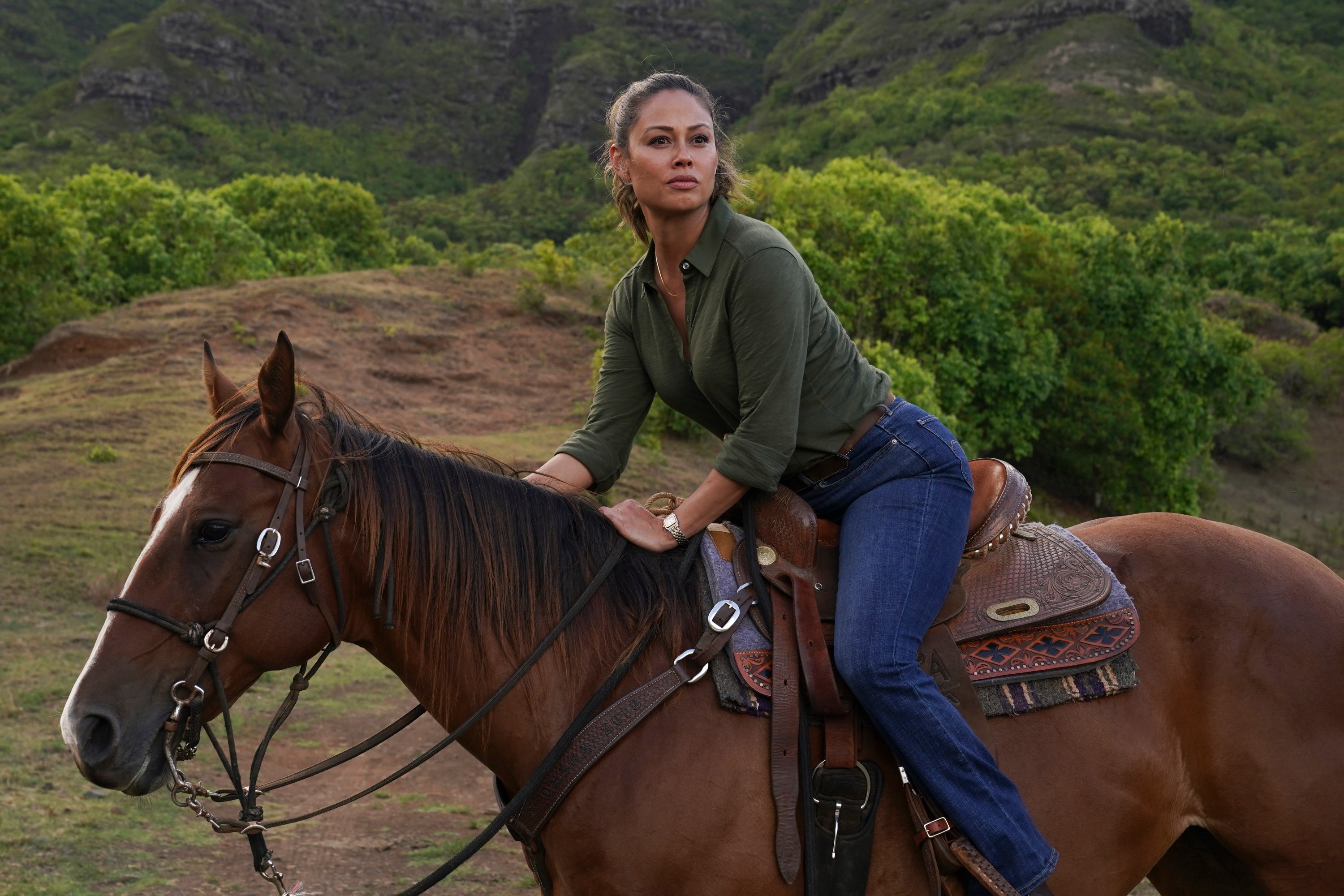 Vanessa Lachey sits on a horse during a scene from 'NCIS: Hawaii'