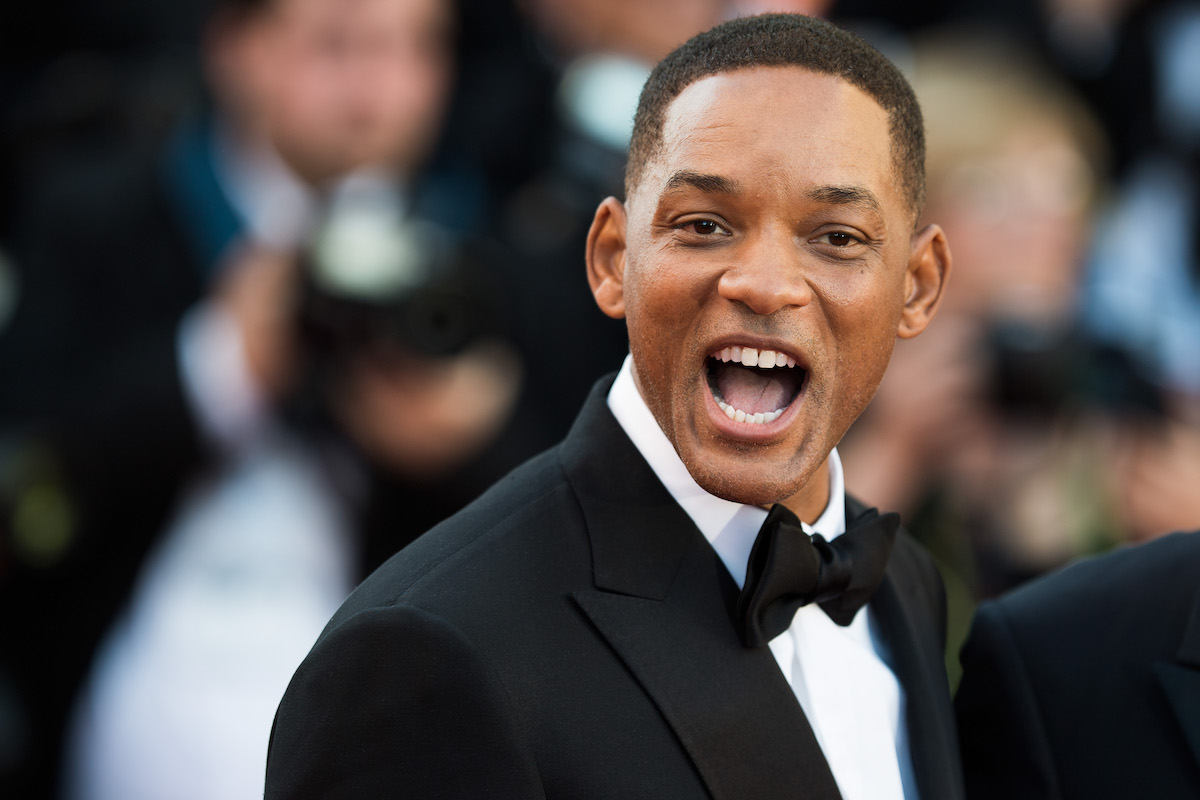 Will Smith looks at the camera with an open mouth.