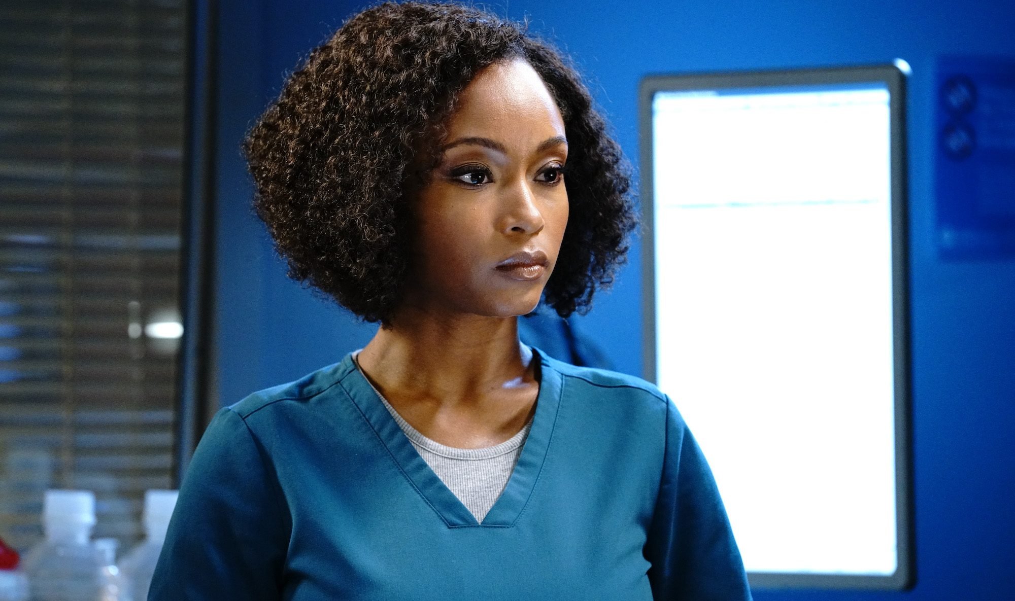 Yaya DaCosta wearing blue hospital scrubs in 'Chicago Med.'