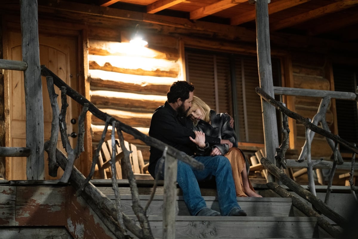 Cole Hauser as Rip Wheeler and Kelly Reilly as Beth Dutton return for Yellowstone Season 4. The couple sit on the stairs and hold each other.