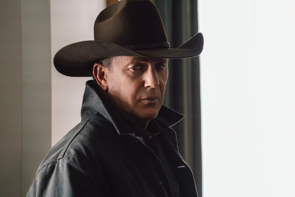 Kevin Costner as John Dutton in Yellowstone. John is wearing a hat and coat. 