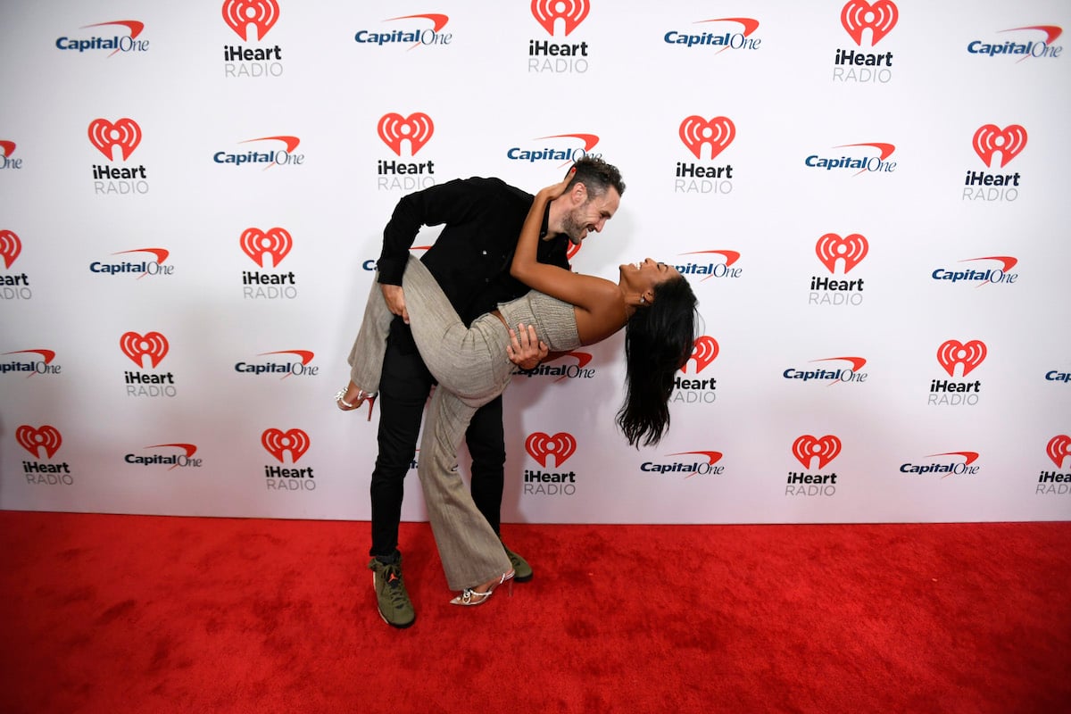 Zac Clark dips fiance Tayshia Adams at an event.