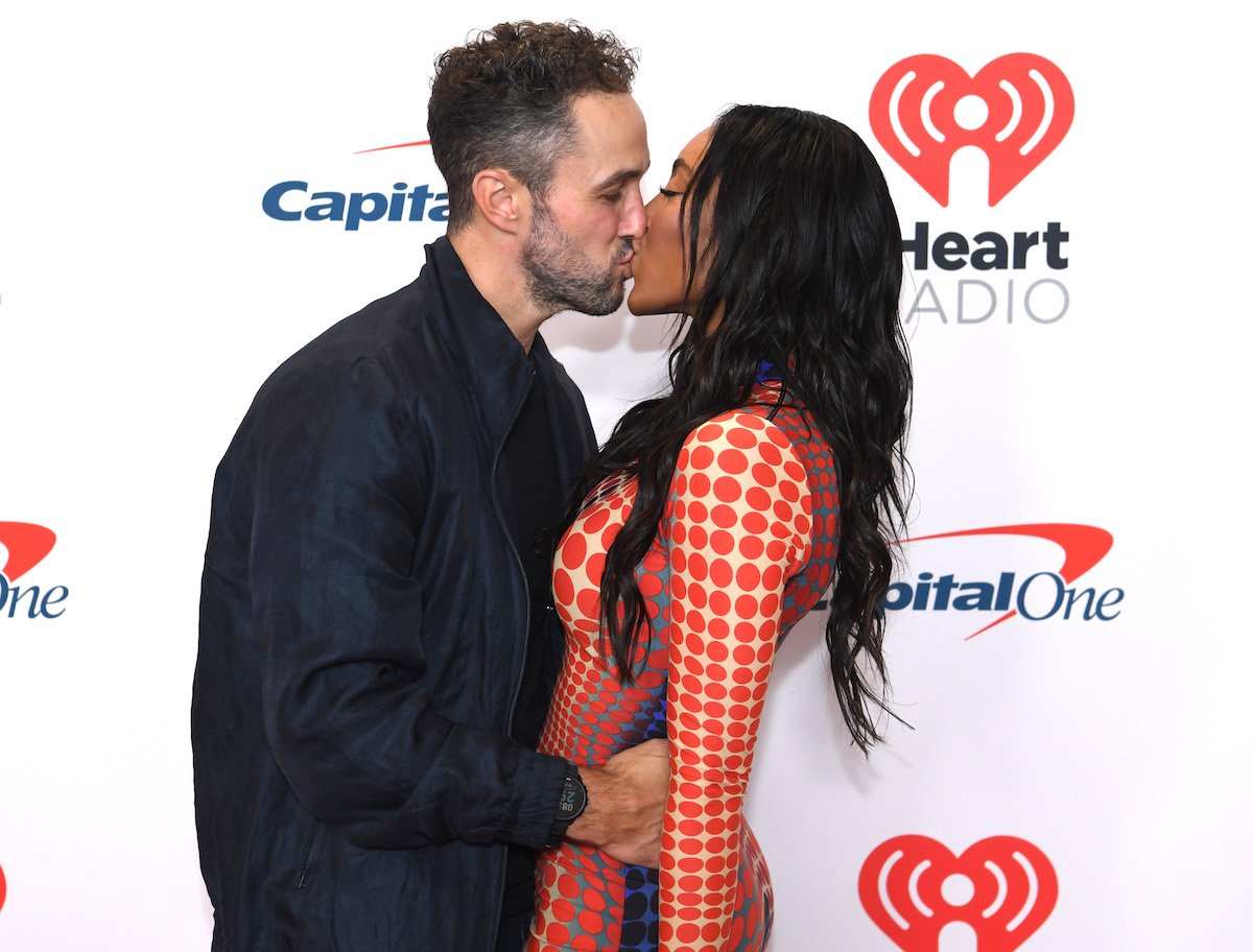 Zac Clark and Tayshia Adams kiss at an event.