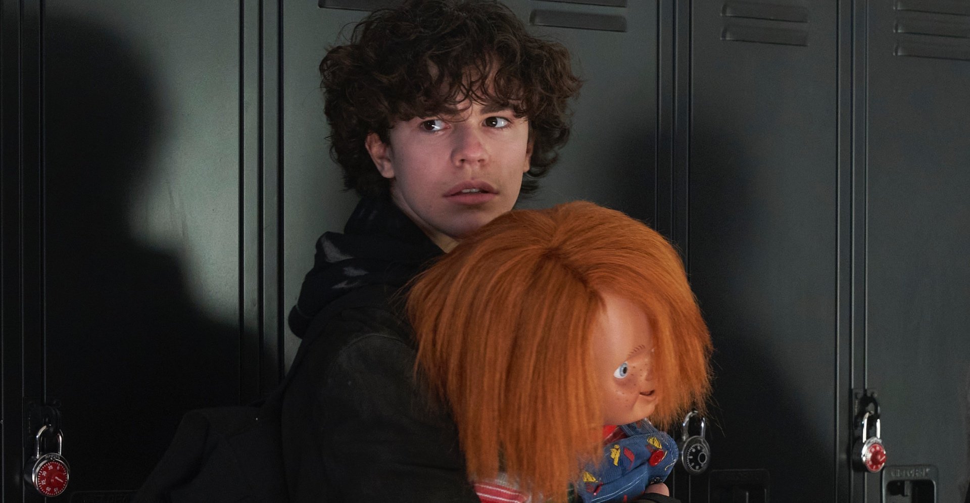 Zackary Arthur as Jake Wheeler for 'Chucky' TV series holding Good Guy doll.