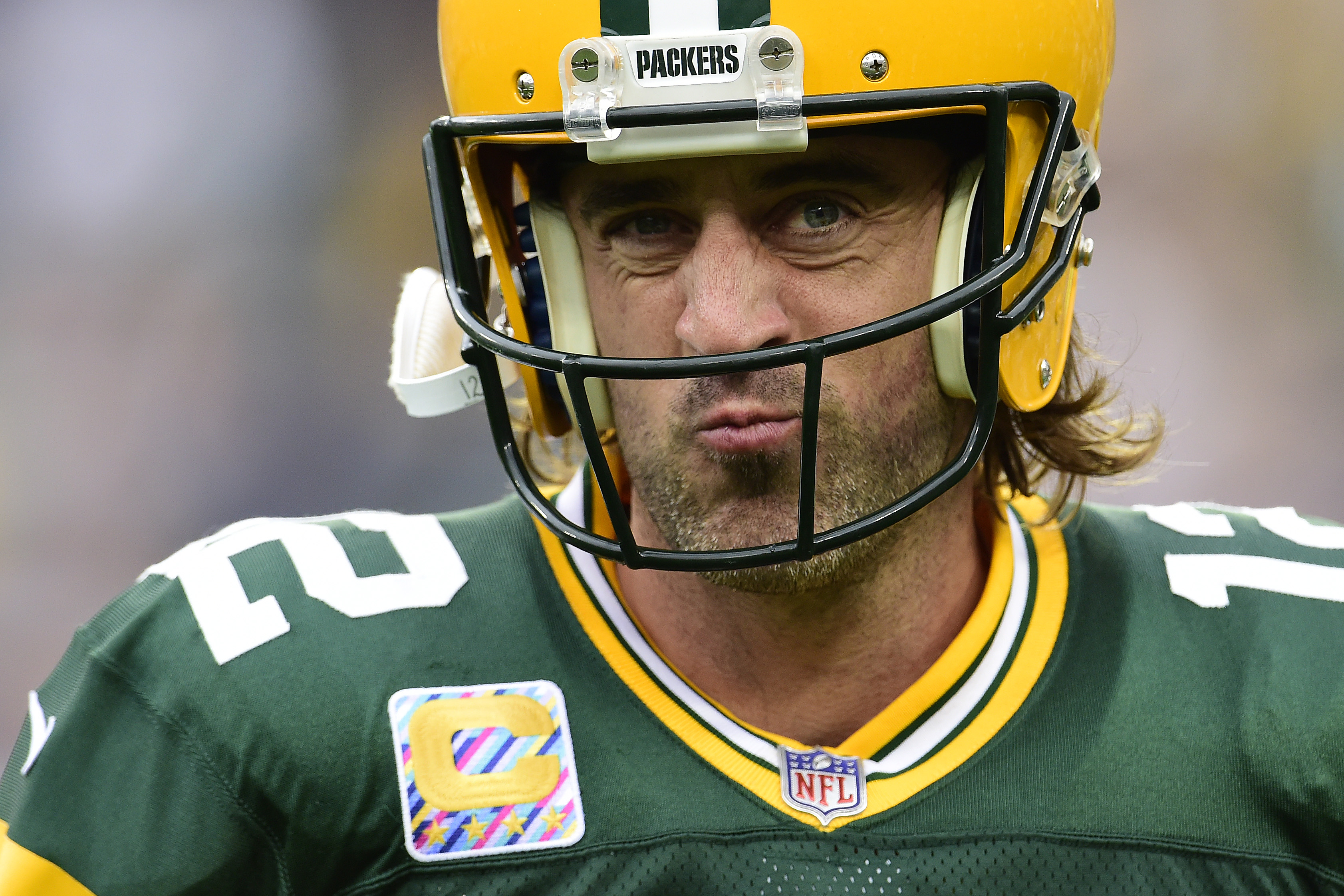 Aaron Rodgers squints with his Green Bay Packers gear on