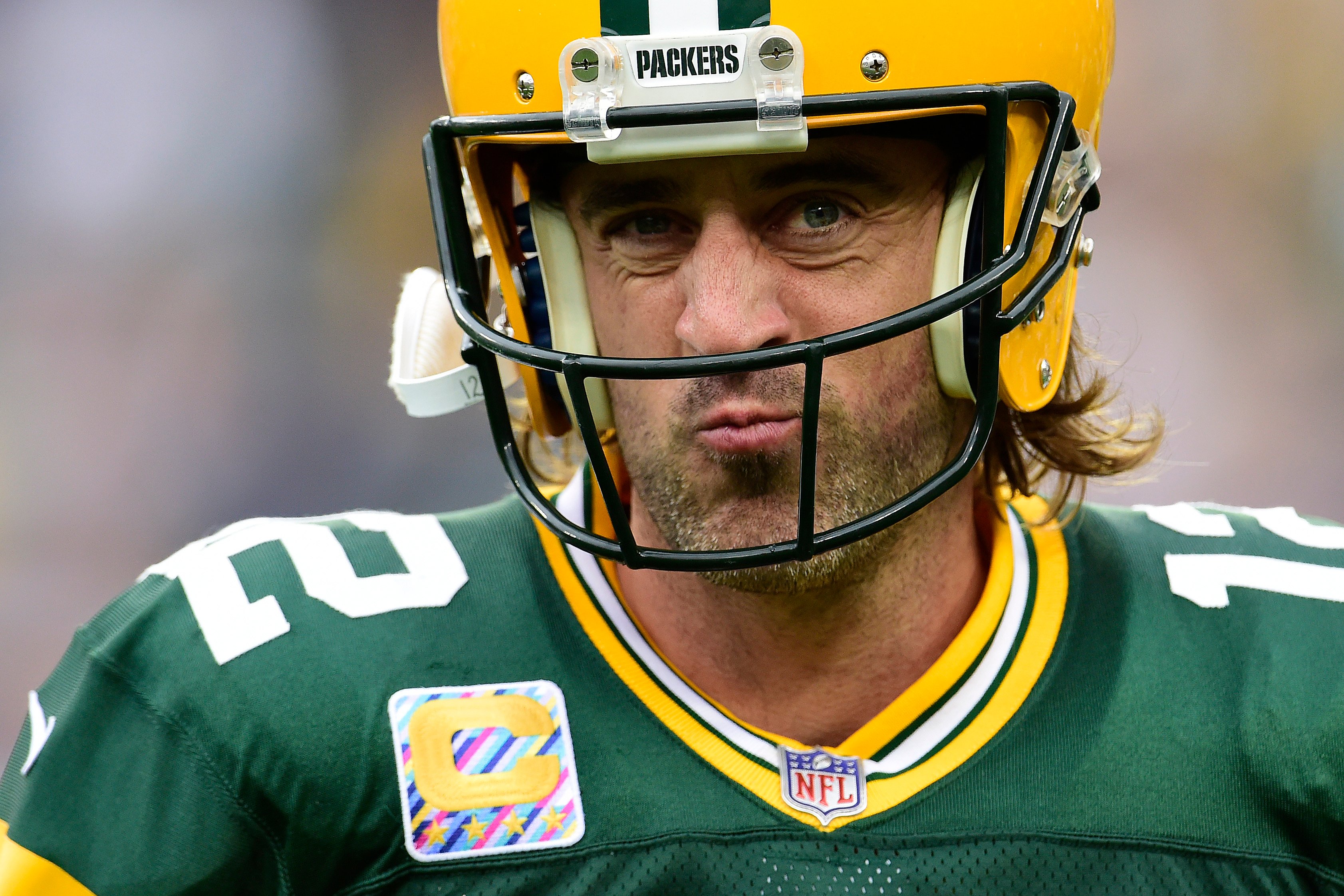 Aaron Rodgers squints with his Green Bay Packers gear on