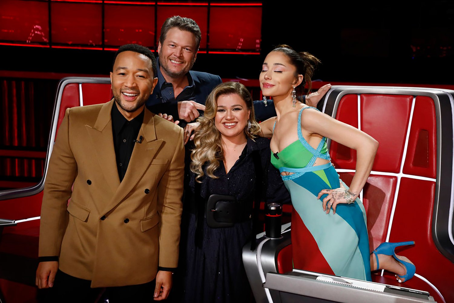 The Voice coaches John Legend, Blake Shelton, Kelly Clarkson, and Ariana Grande, who wears the iconic Jenna Rink dress from 13 Going On 30