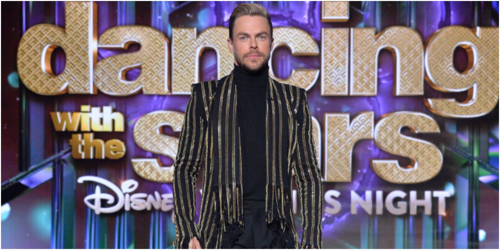 Derek Hough wears a black turtleneck on the set of Dancing with the Stars.