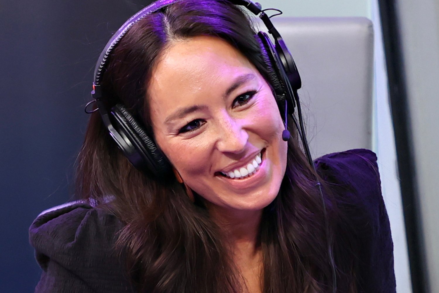 Joanna Gaines wearing headphones and smiling