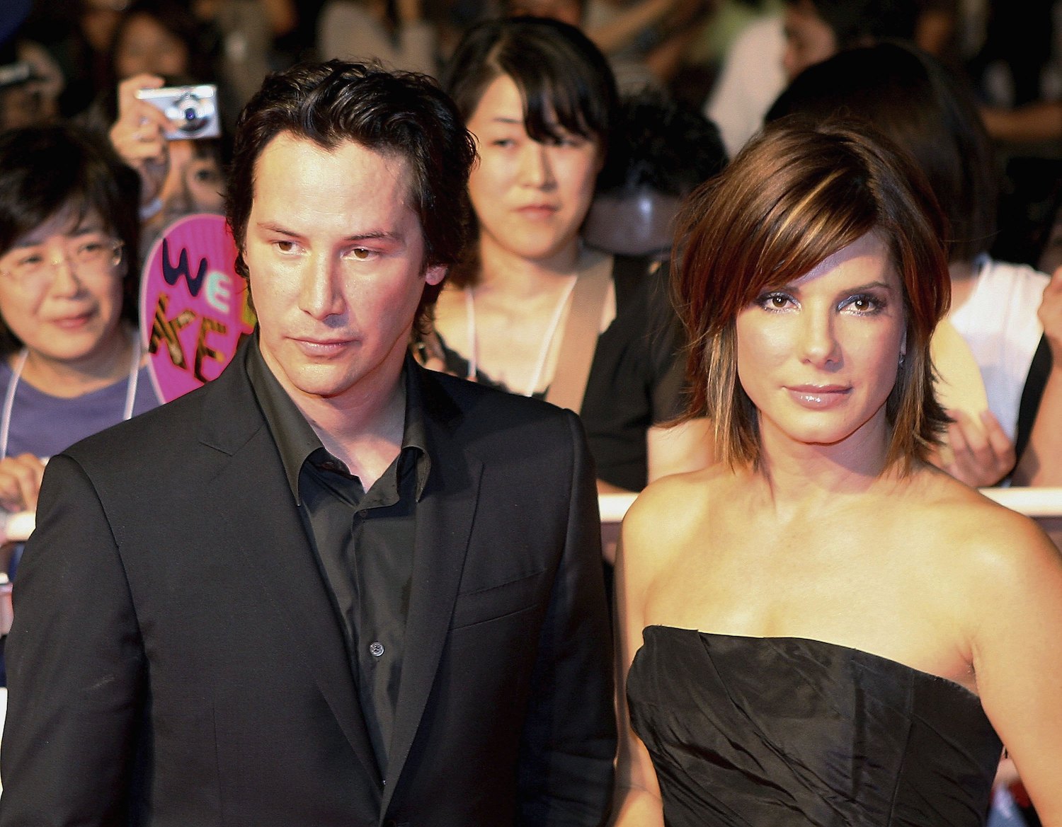 Keanu Reeves and Sandra Bullock, both in black, look serious on the red carpet at the Japanese premiere of 'The Lake House'