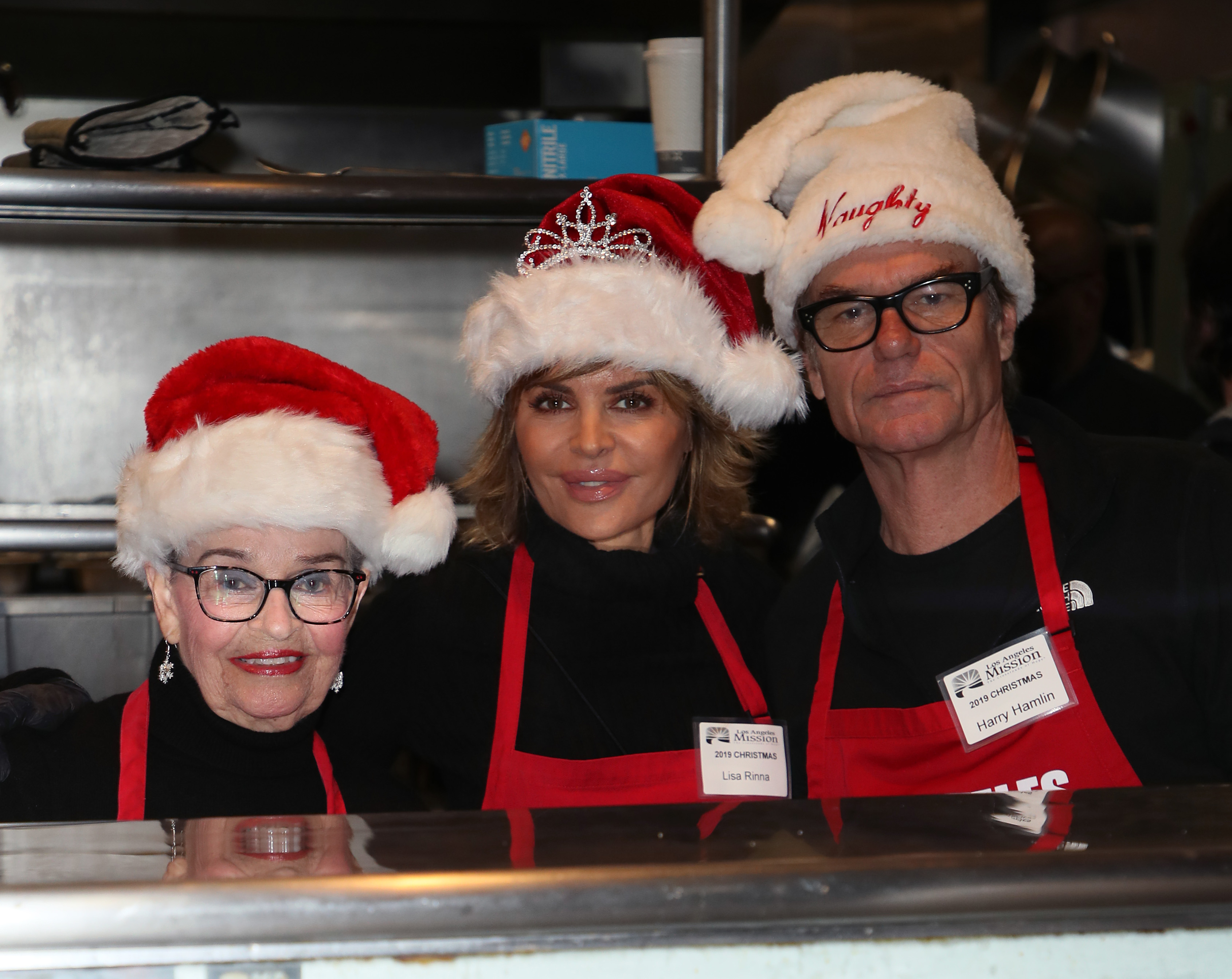 Lois, Lisa Rinna, and Harry Hamlin wearing Santa hats and smiling