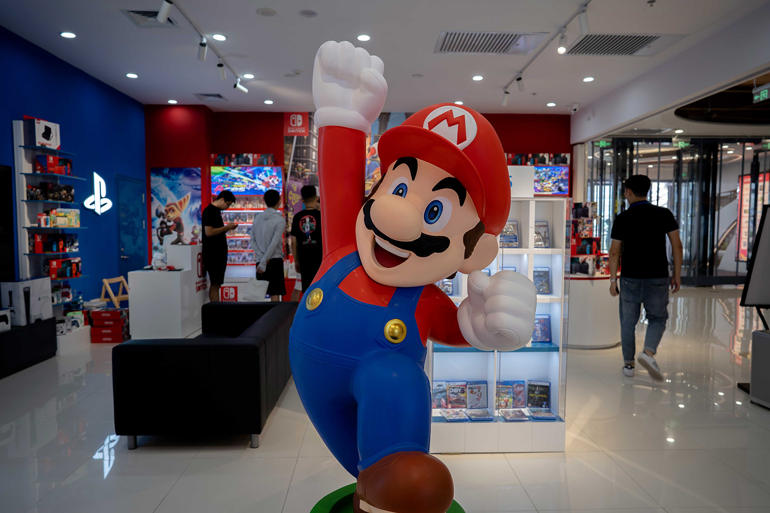 A cartoon Super Mario Bros. figure in front of a game store