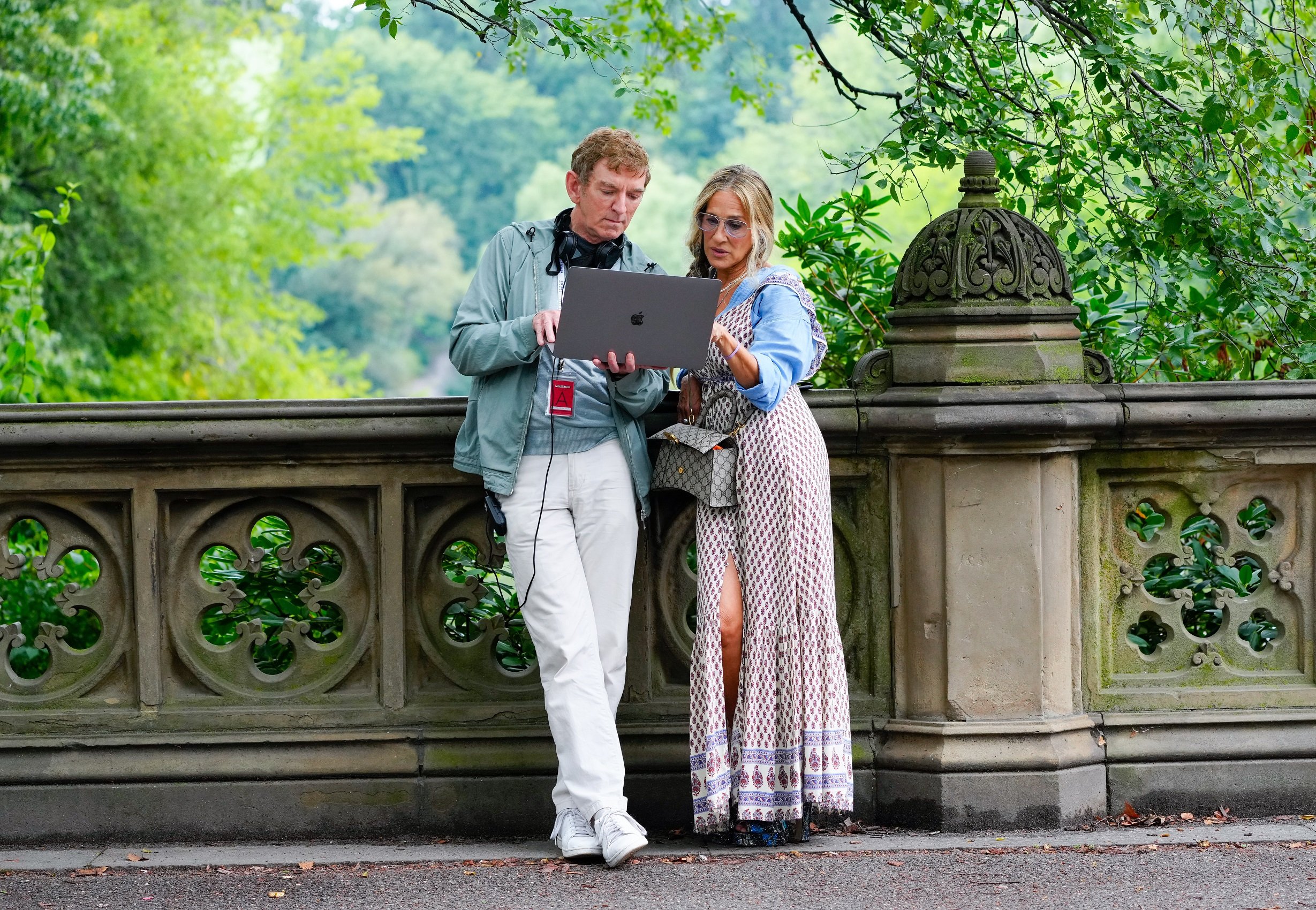 Michael Patrick King and Sarah Jessica Parker look at a laptop together on the set of 'And Just Like That...', the 'Sex and the City' reboot in August 2021
