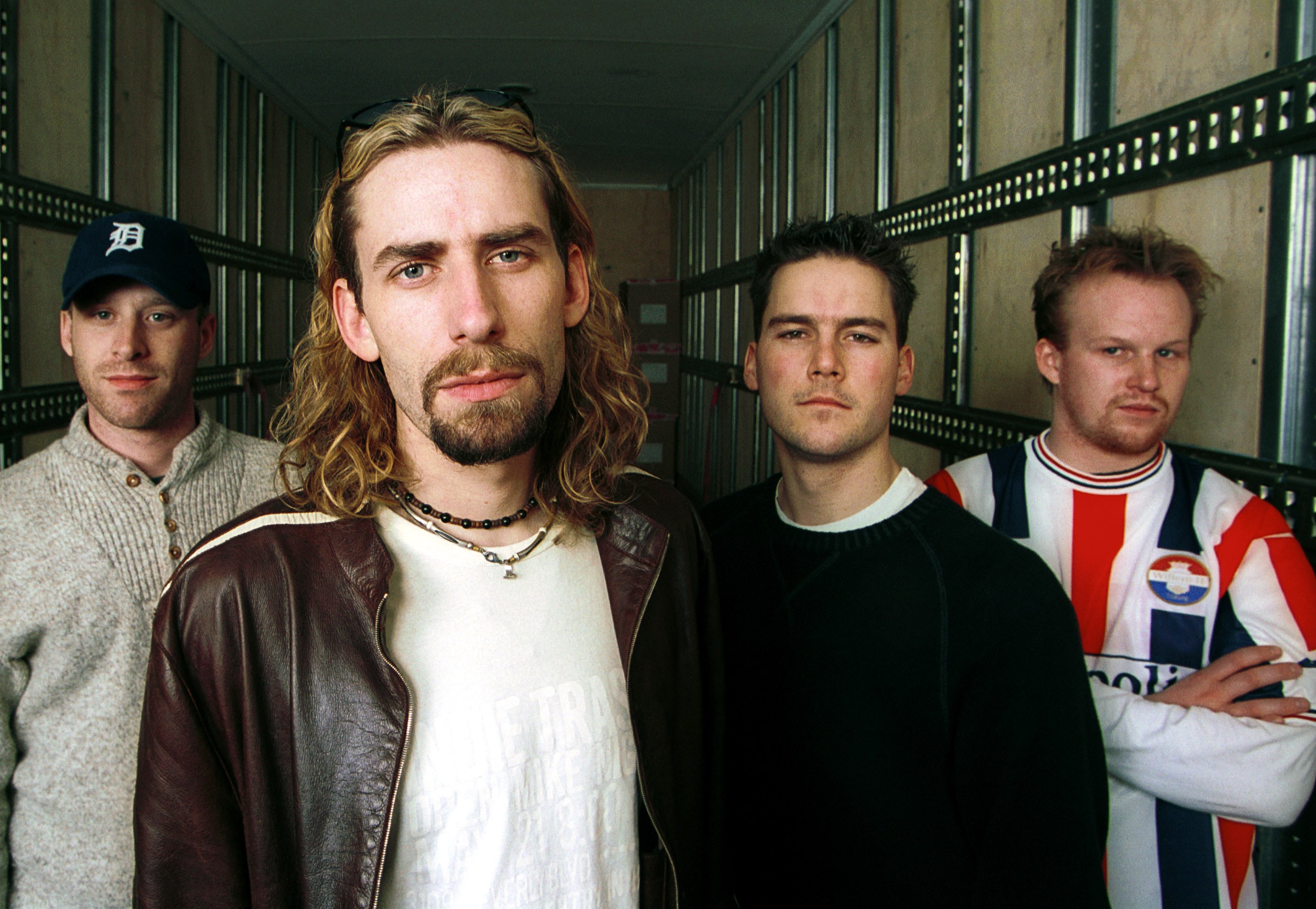 Nickelback members standing in a row