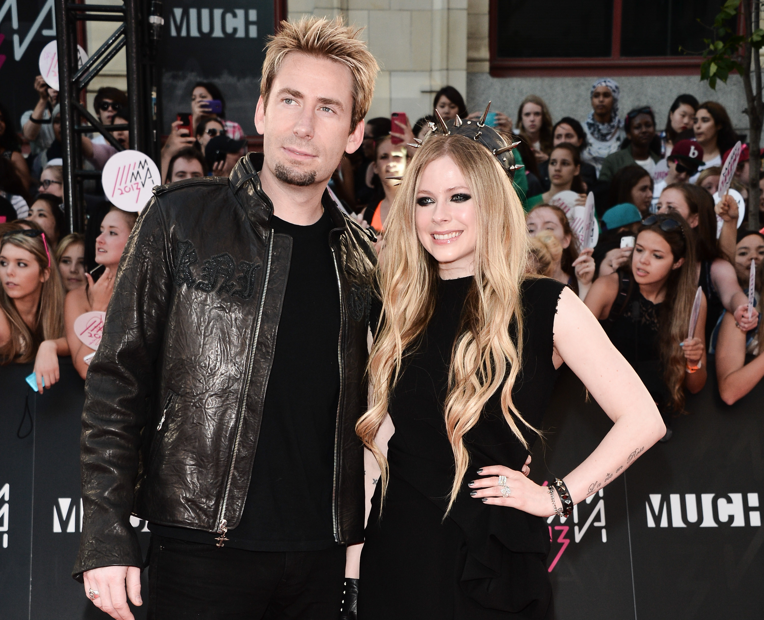 Nickelback's Chad Kroeger with Avril Lavigne in front of a crowd