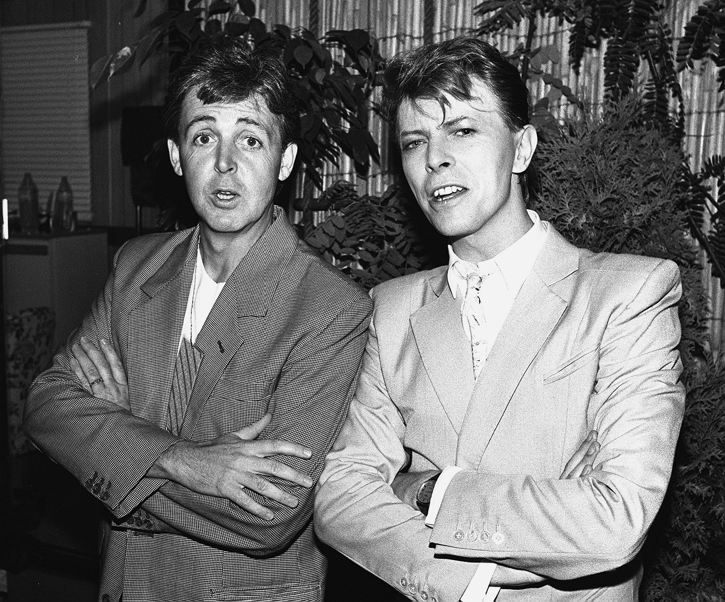 Paul McCartney and David Bowie wearing suits