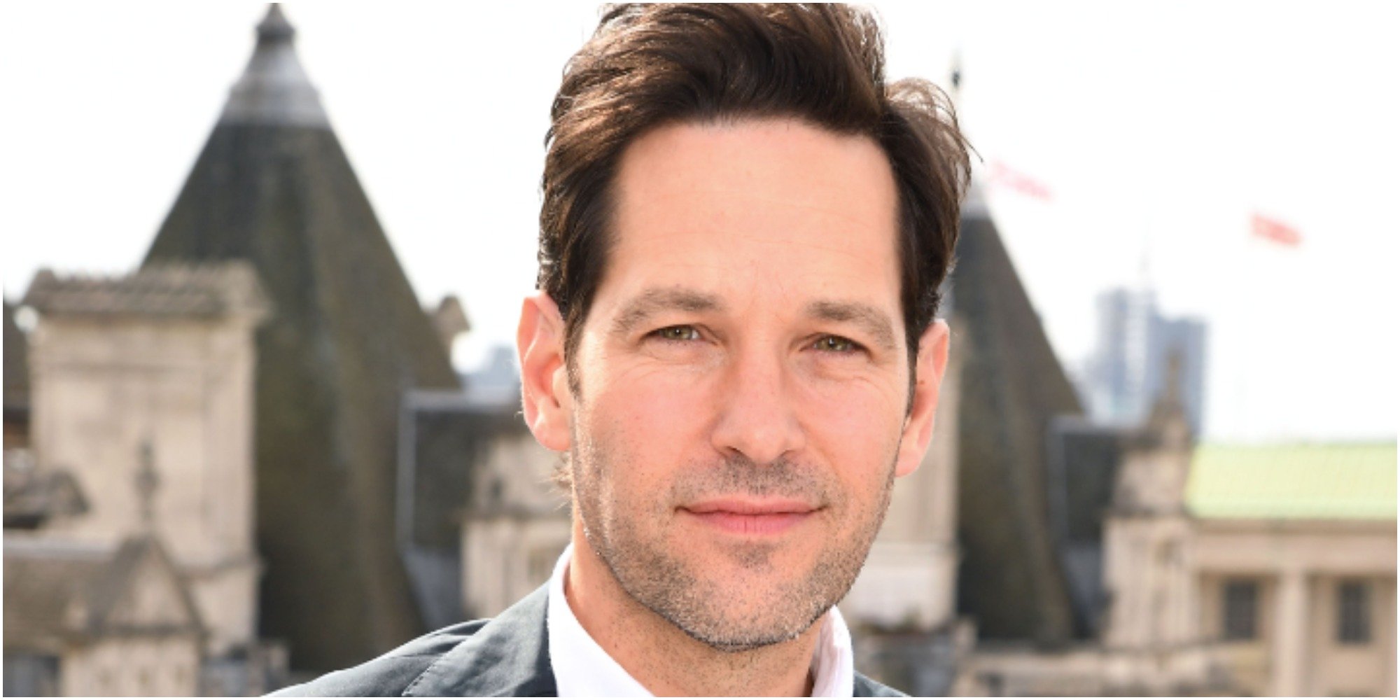 Paul Rudd wears a suit as he poses for photographers.