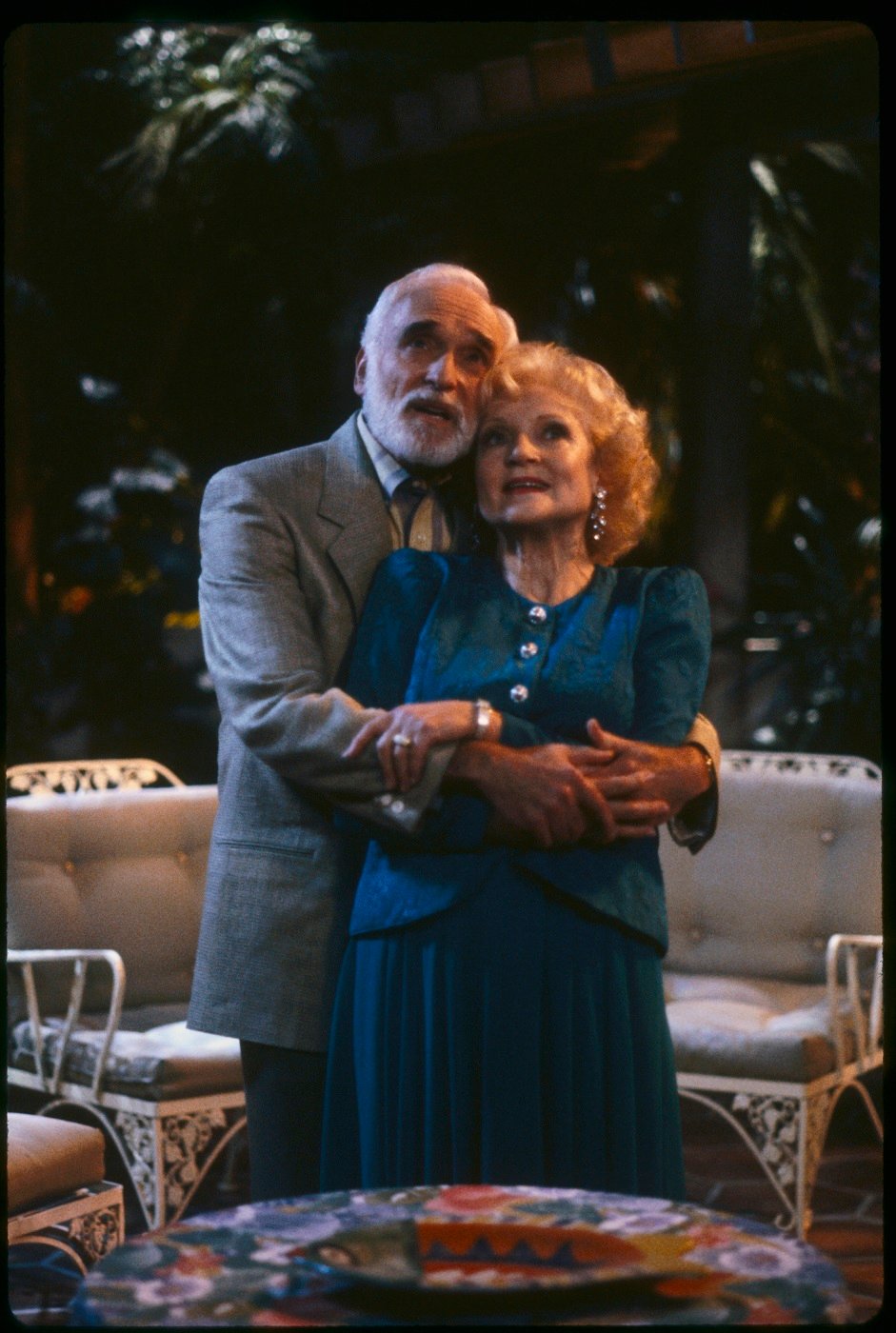 Harold Gould as Miles Webber and Betty White as Rose Nylund stand on the lanai in 'The Golden Girls'